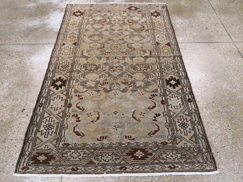 An antique Persian Malayer rug. This rustic west Persian scatter has a simplified allover Herati leaf and rosette pattern on the abrashed slate ground. The geometric vine and ashik light buff main border are flanked by boteh chain