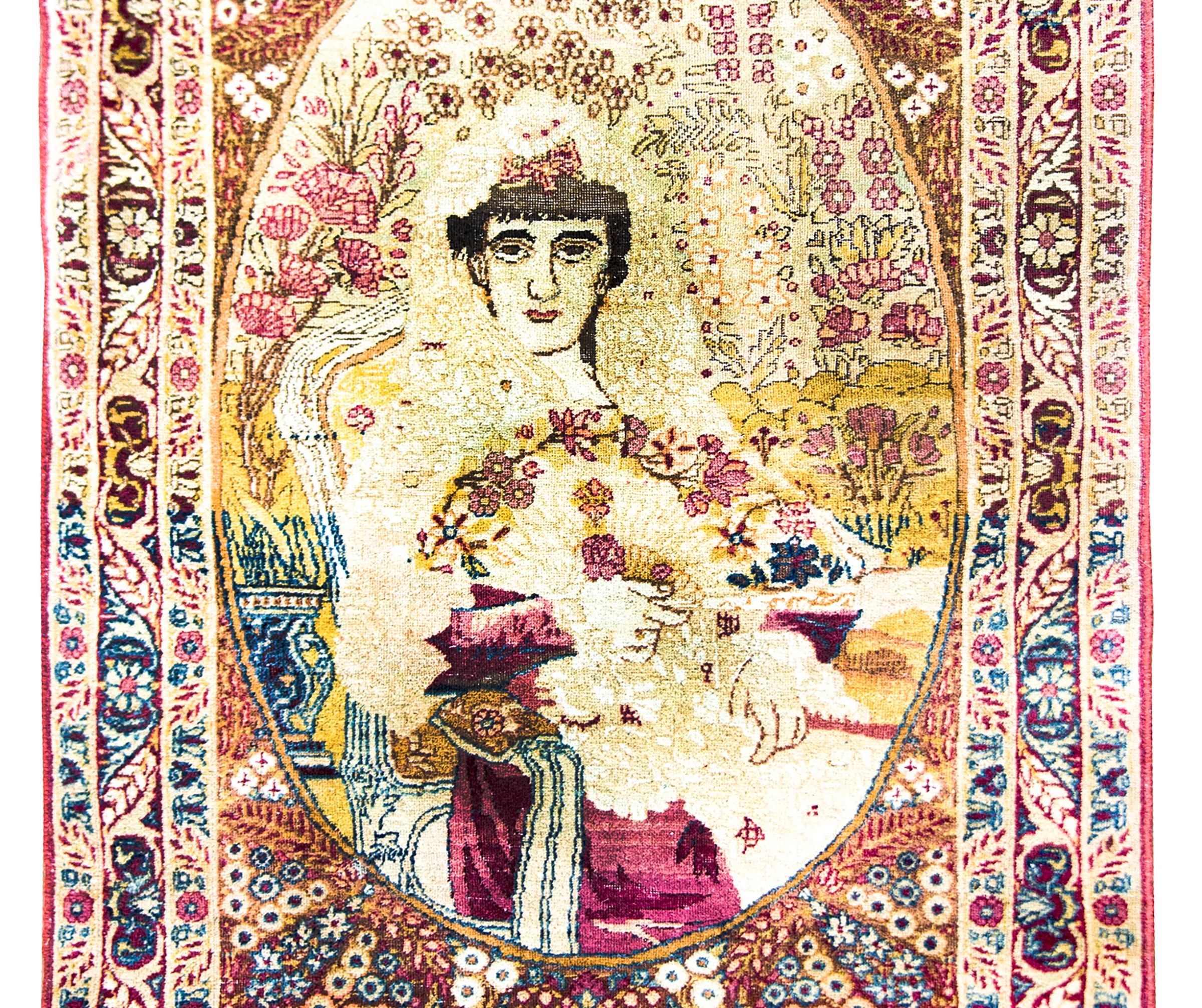 Early 20th Century Persian Pictorial Lavar Kirman rug depicting Taj al-Saltaneh (1884 – January 25, 1936) who was a princess of the Qajar dynasty.  She was a writer, a painter, an intellectual, and an activist who hosted literary salons at her house