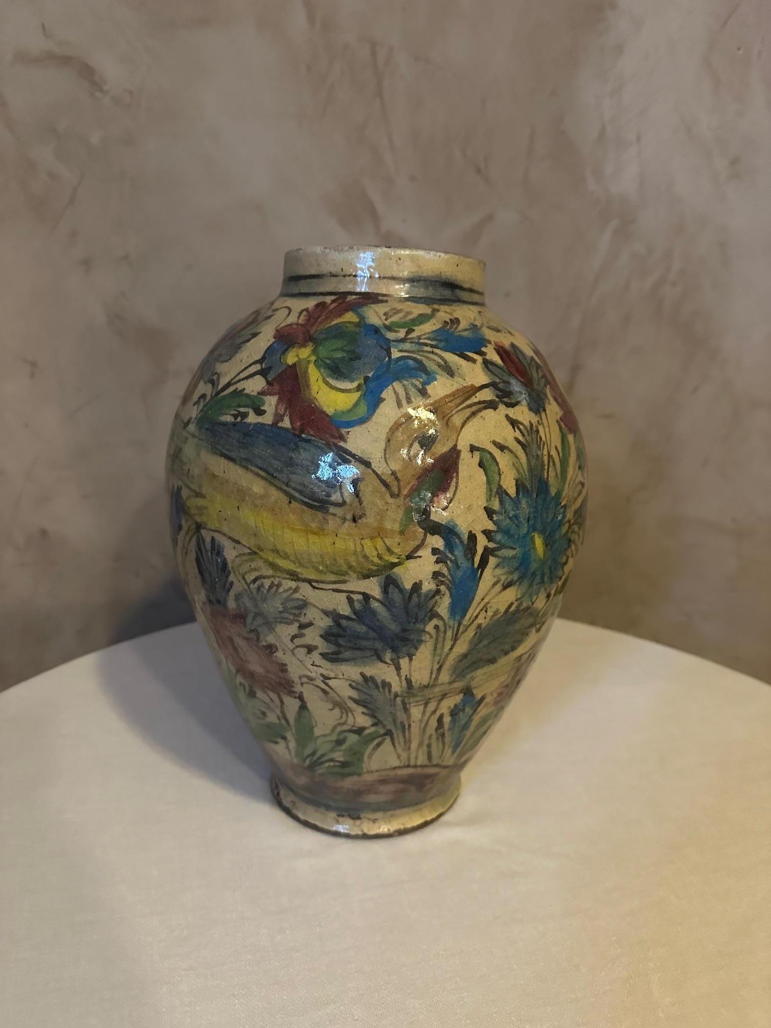Very beautiful vase in enamelled polychrome painted ceramic. 
Persian, Qajar dynasty dating from 1900. 
Beautiful painted decoration of birds and flowering branches. 
Nice quality. Small chip below the foot.
​