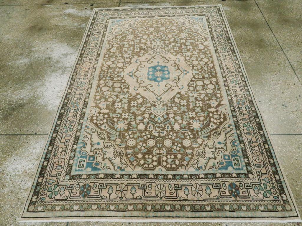 An antique Persian Sarouk accent rug handmade during the Early 20th century.

Measures: 4' 5