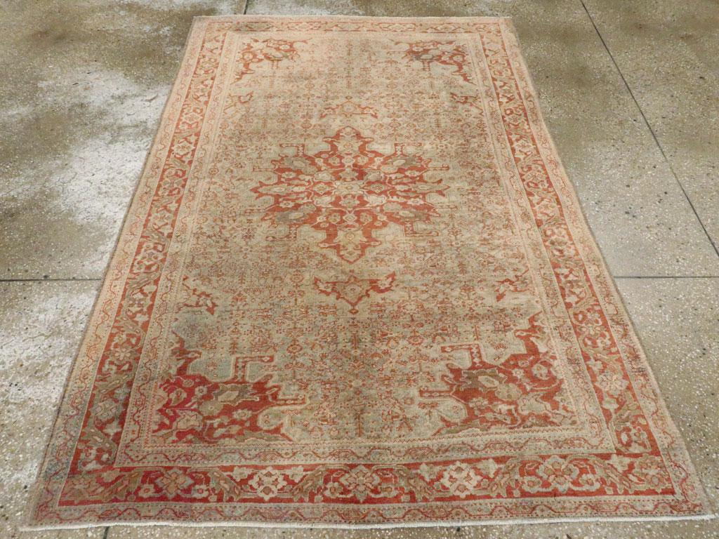 An antique Persian Sarouk Fereghan accent rug handmade during the Early 20th century.

Measures: 4' 3