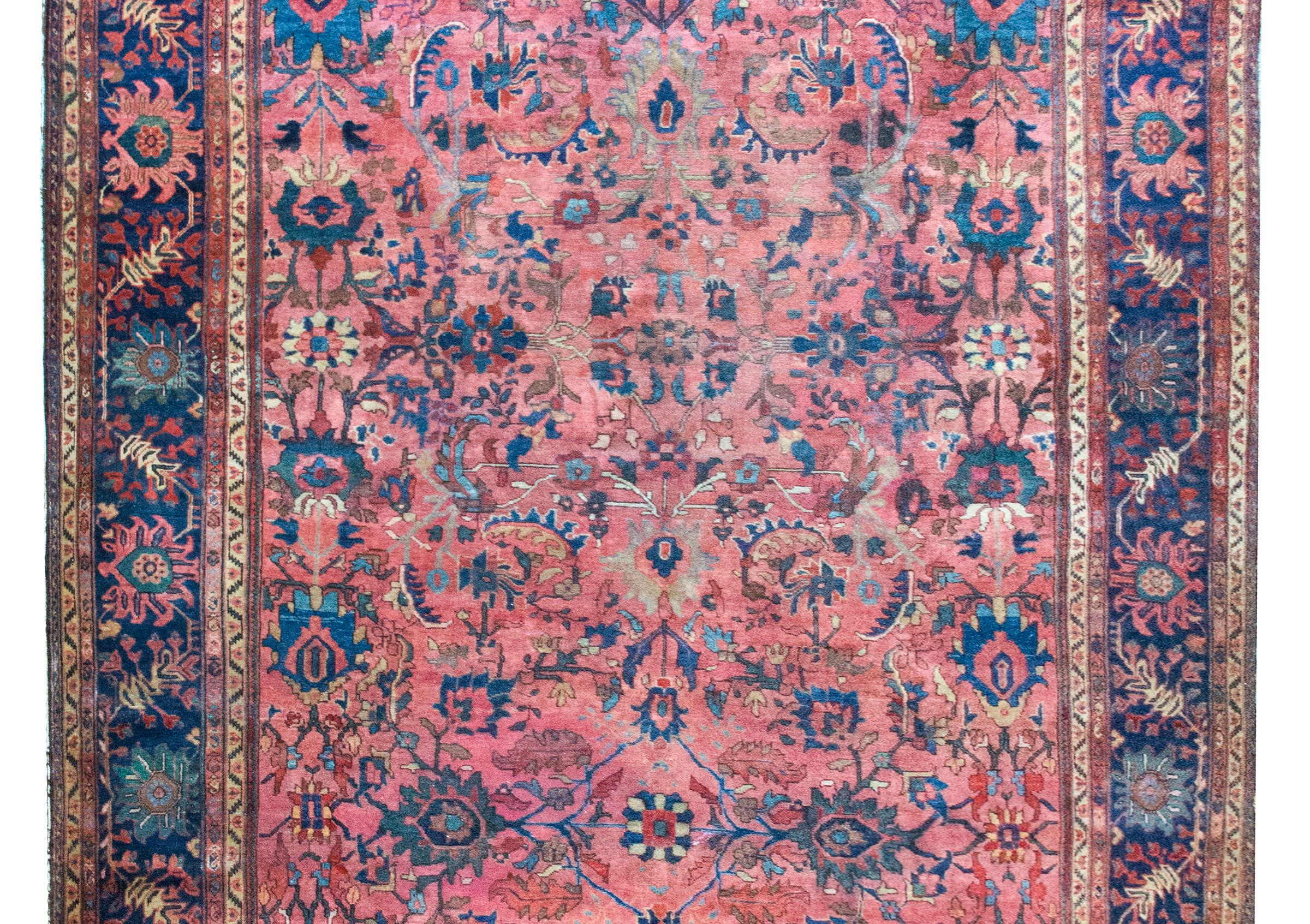 This exceptional early 20th-century Persian Sarouk Farahan rug is a striking example of one of the most sought-after and collectible weaving traditions in Iran. Woven in the Farahan region of western Iran, Sarouk Farahans are prized for their