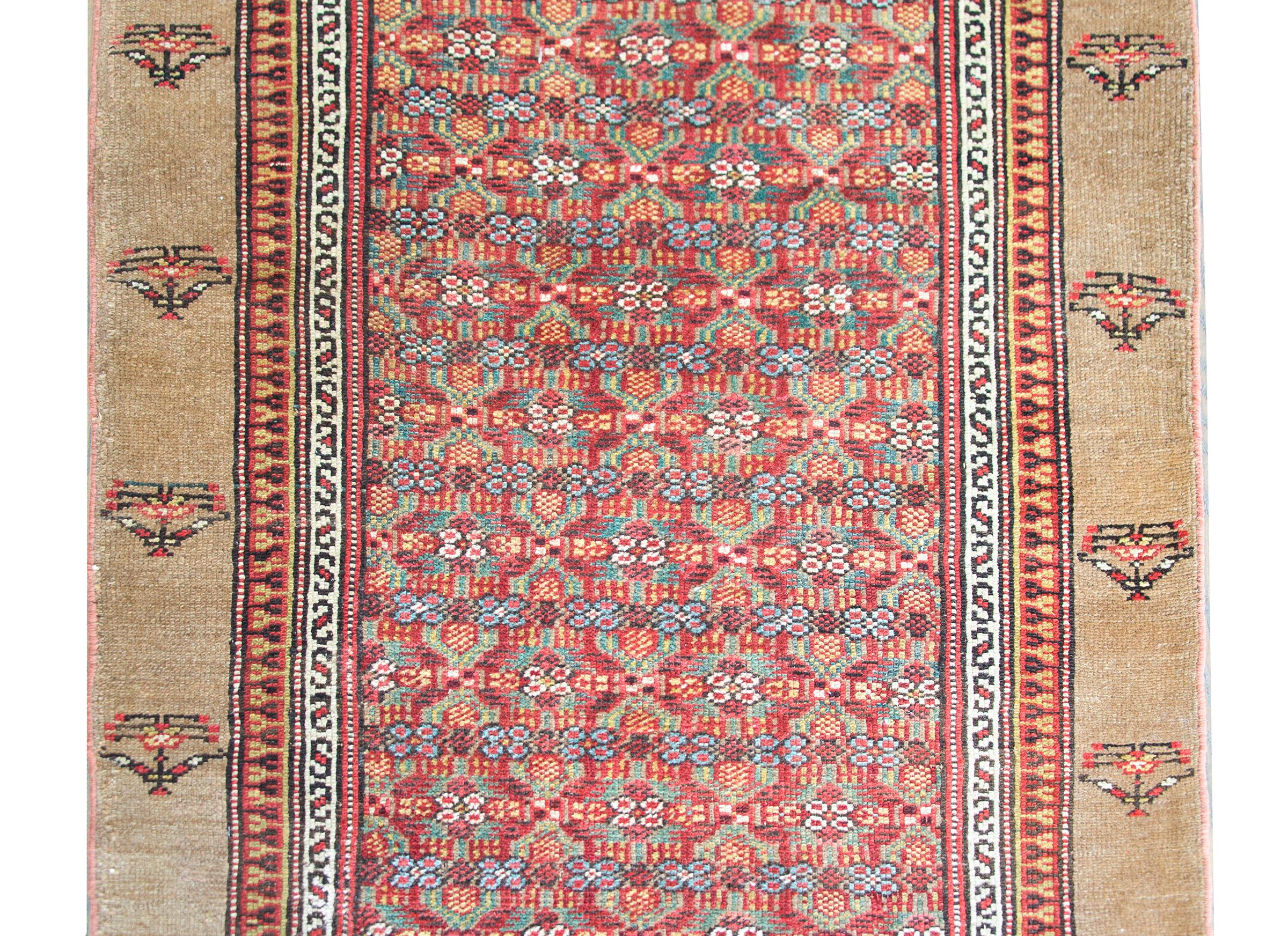 A stunning early 20th century Persian Serb runner with an all-over floral trellis pattern woven in crimson, green, light indigo, and gold, and surrounded by a border composed of thin geometric pattered inner stripes and a wide natural camel hair
