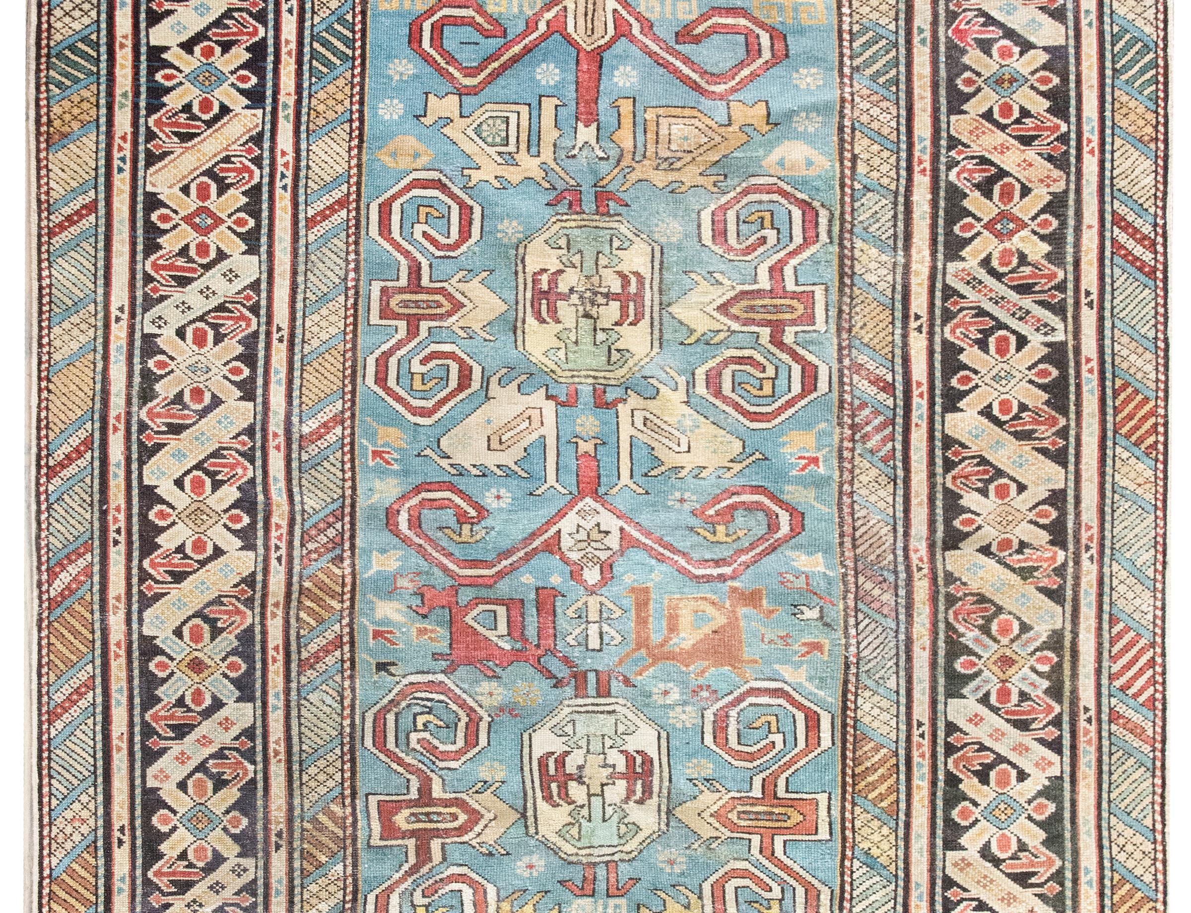 This early 20th-century Persian Shirvan rug is a masterclass in color, composition, and scale. Woven by Azerbaijani artisans from the Shirvan region in the eastern Caucasus—an area long celebrated for its intricate village weavings—this piece