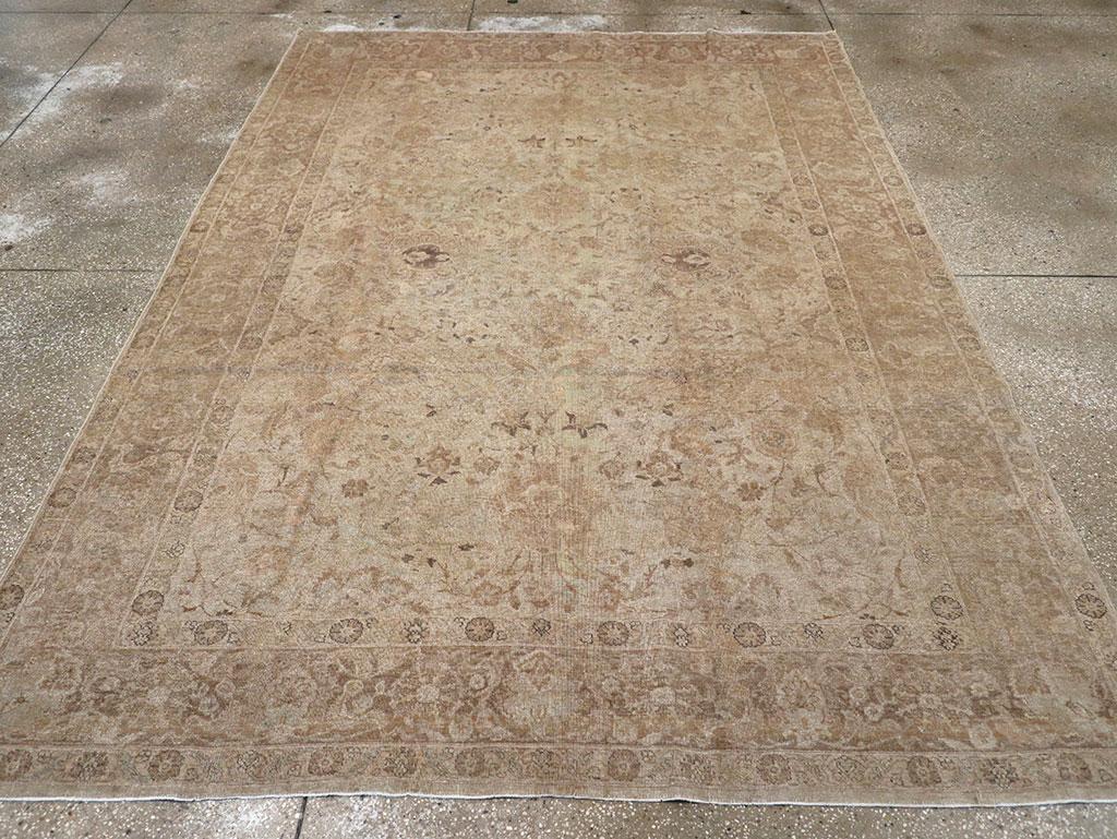 A wool pile of symmetric knots on a cotton foundation. In a generally light-toned palette, this small city carpet features a sandy field with a close scatter of bracketed and other palmettes, along with leaves, accented in dark brown. Cloud bands,