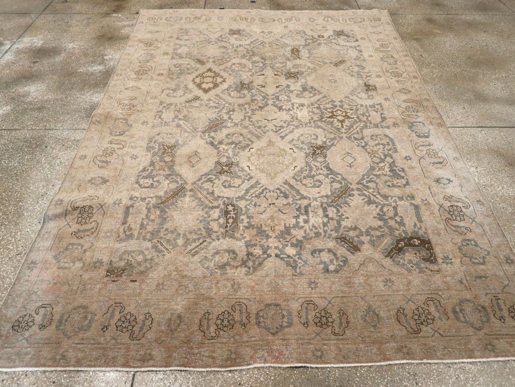 A wool pile of symmetric knots on a cotton foundation. The slate gray to charcoal field features an extended composition of pruning-hook leaves emerging from lozenge-shaped plaquettes, arranged in an offset pattern clearly influenced by early