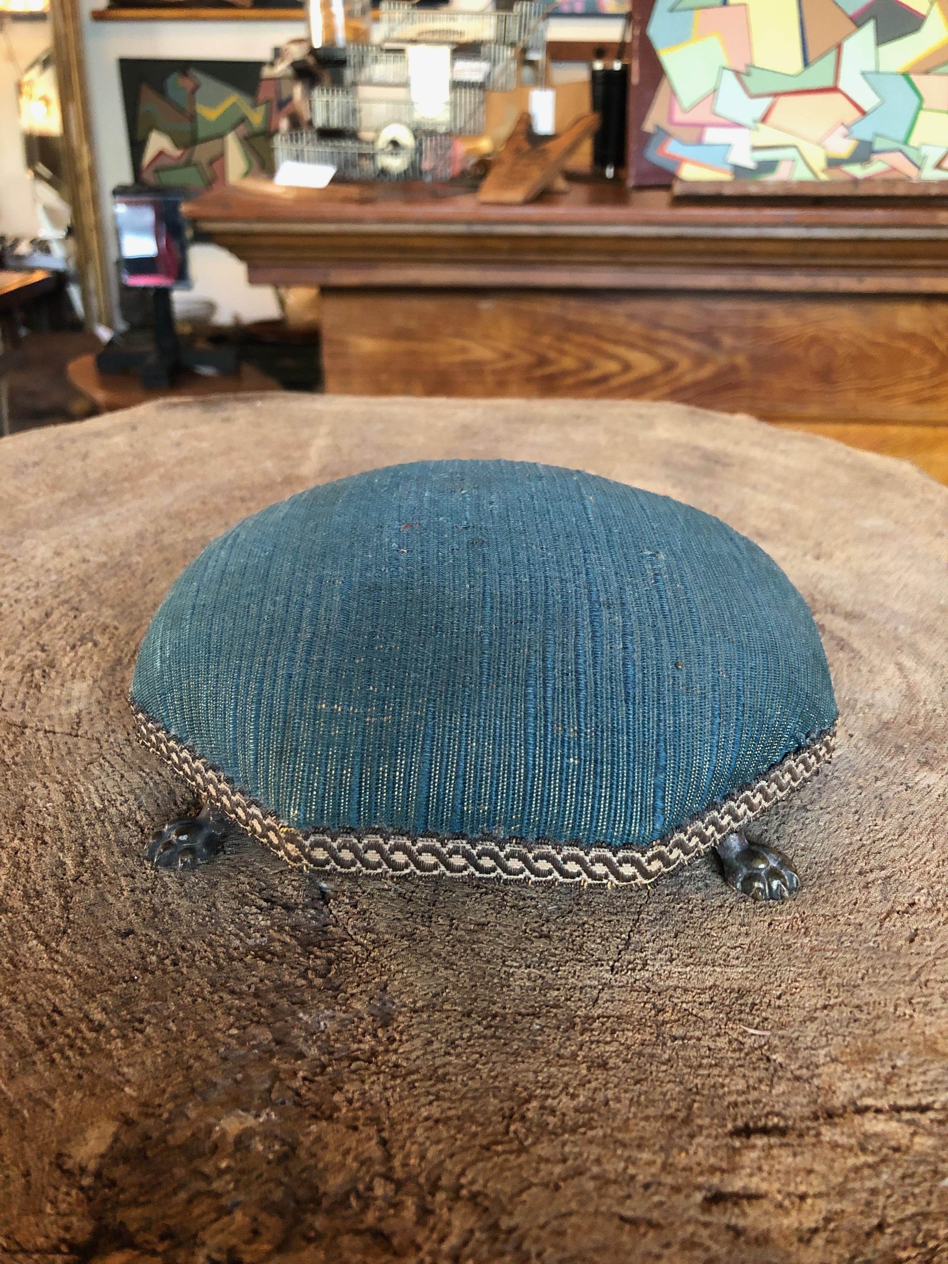 This is a fabulous early 20th century pin cushion with brass claw feet covered in original cornflower blue fabric. Great for displaying jewelry. Other pin cushions available as seen in photo.