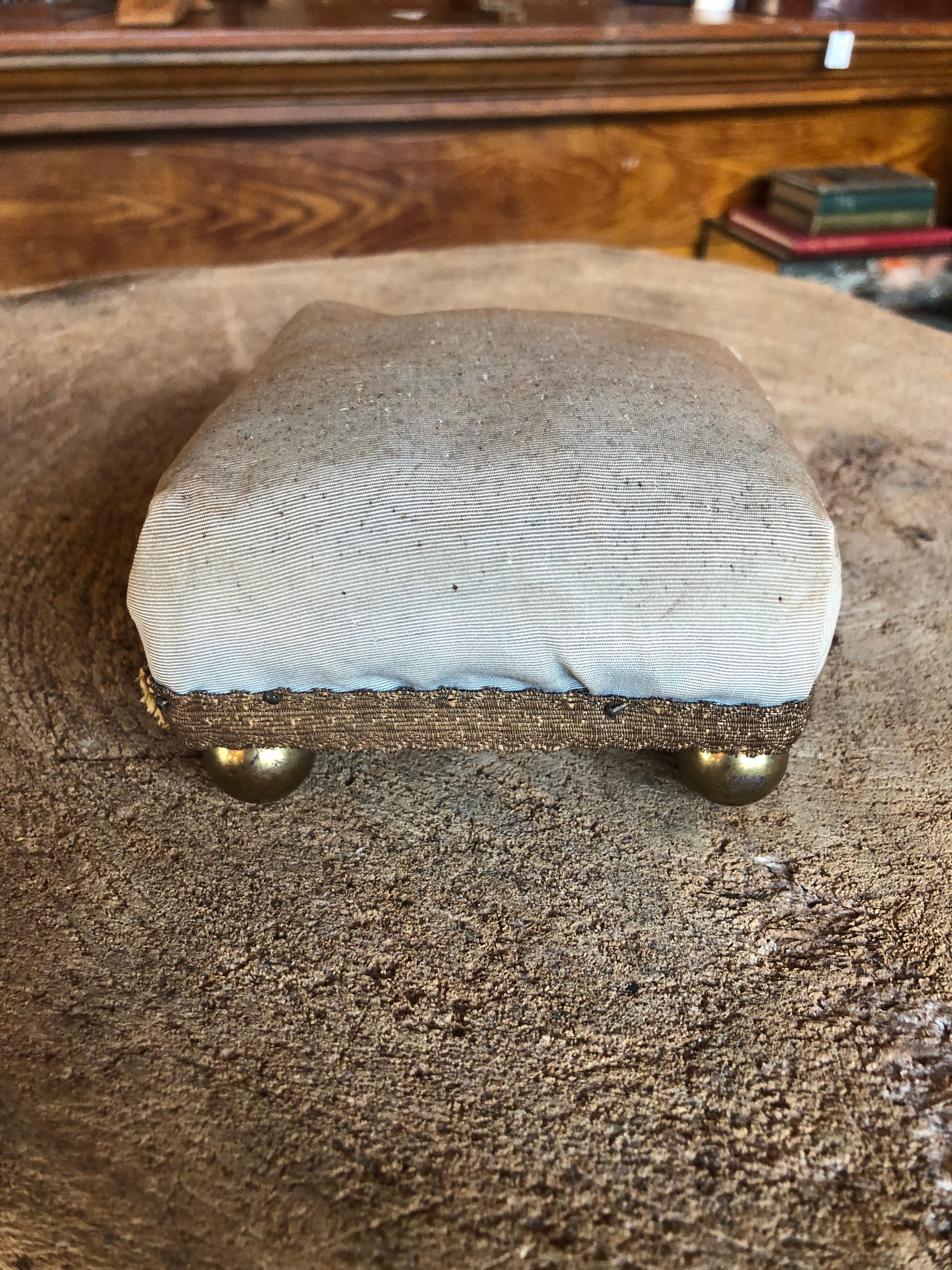 This is a fabulous early 20th century pin cushion with brass ball feet covered in original faded blue fabric. Great for displaying jewelry. Other pin cushions available as seen in photo.