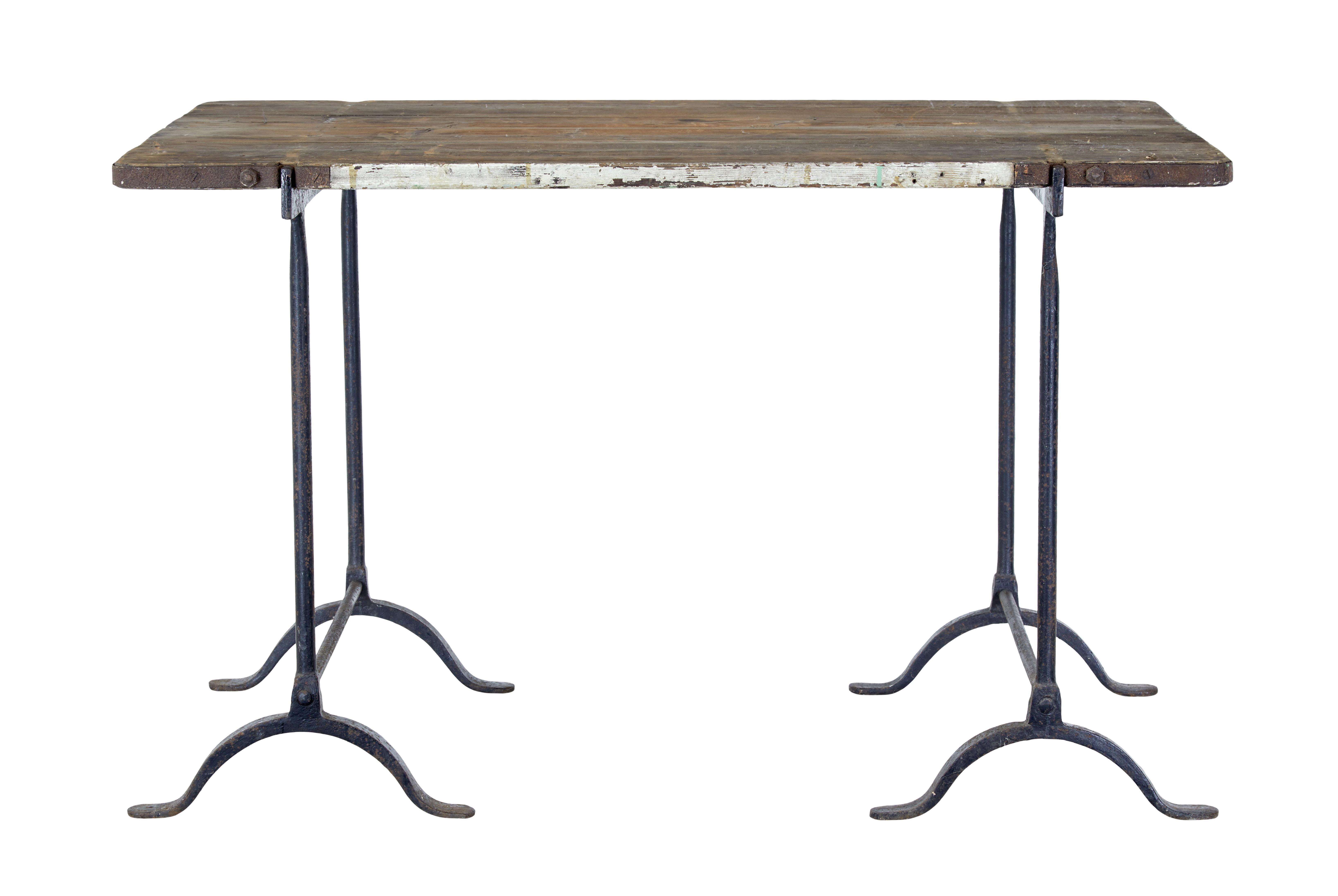 Early 20th century pine and iron trestle work table circa 1900.

Good quality trestle work table, which is more rare than the normal as the top has always been with the bases, as the top has specially spaced fittings for the cast iron