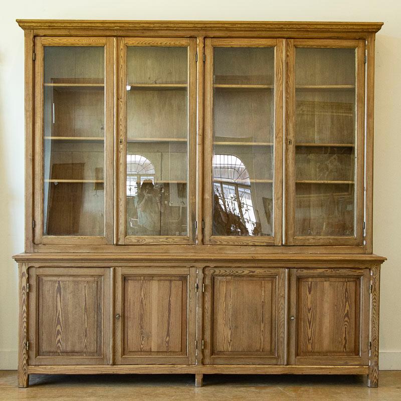 This large pine bookcase has four tall glass doors allowing for ideal display options. The interior shelves are adjustable; see the original 