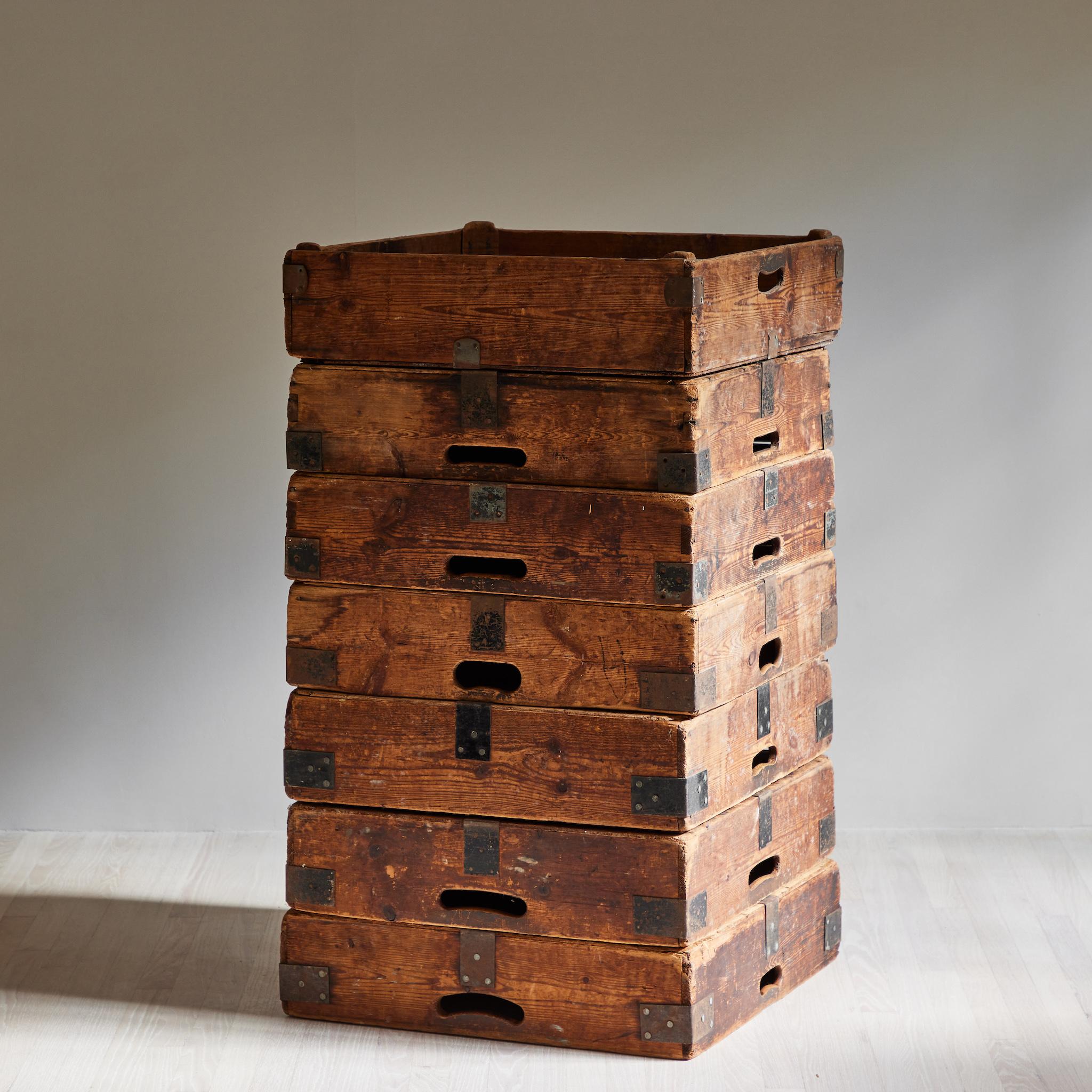 Set of four early 20th-century French wooden planter boxes, originally used to transport pottery. With utilitarian accents and a rustic patina, these industrial boxes bring the feeling of a studio into any space. Can be stacked or displayed