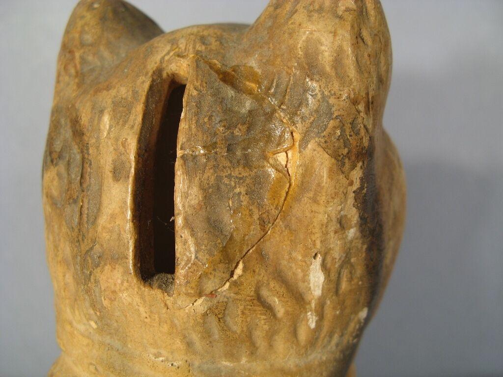 This captivating early 20th century plaster figurine tirelire of a seated cat adds a touch of rustic charm and vintage appeal to any home décor. The intricate details of the cat figurine and the warm, earthy tones of the plaster make it a delightful