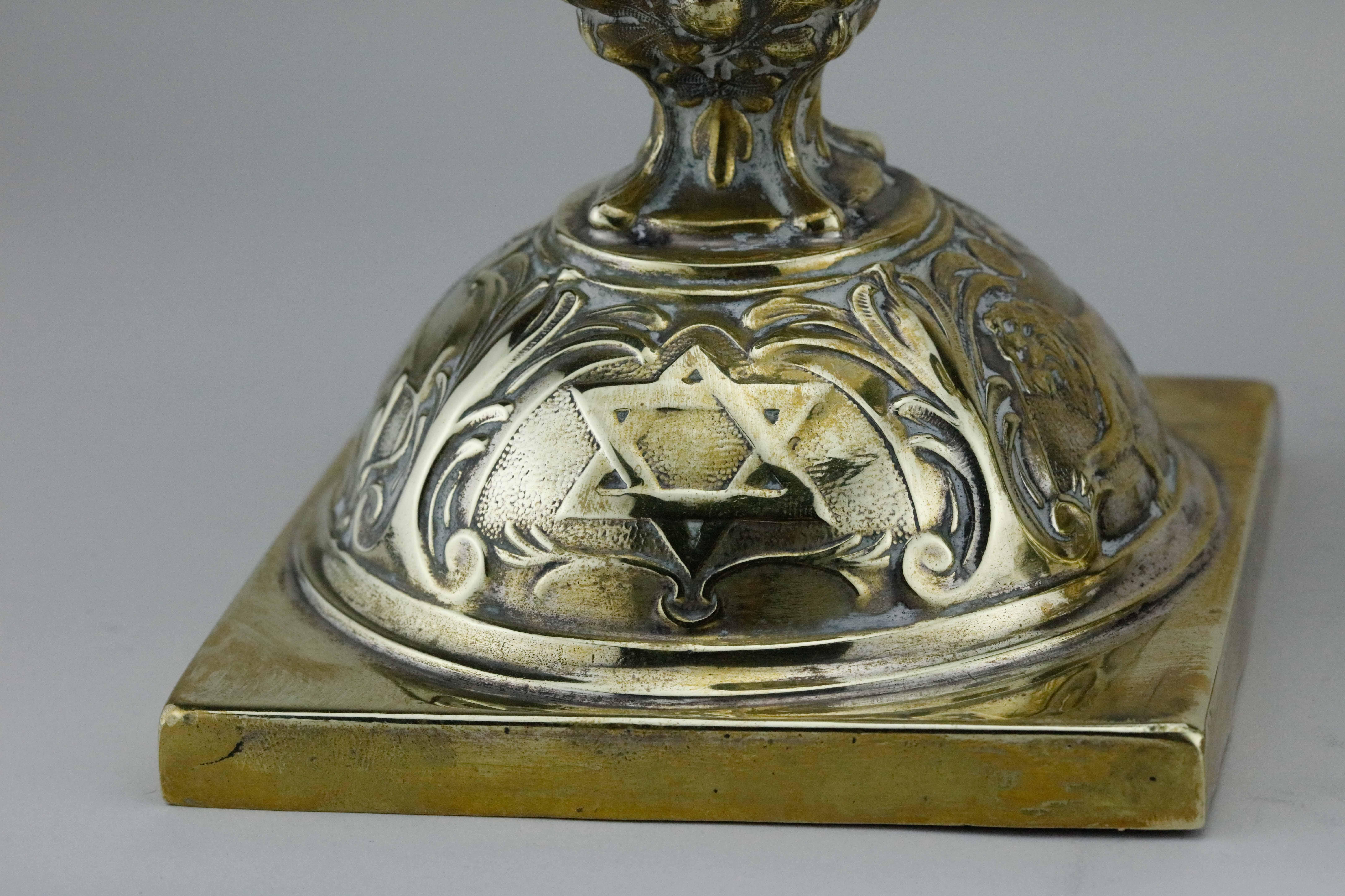 Rare pair of brass Shabbat candlesticks, Warsaw, Poland, 1908.
These matching Shabbat candlesticks, impressed with lions and Star of David, are the result of assembly-line production that was abundant in Warsaw during the end of the nineteenth and