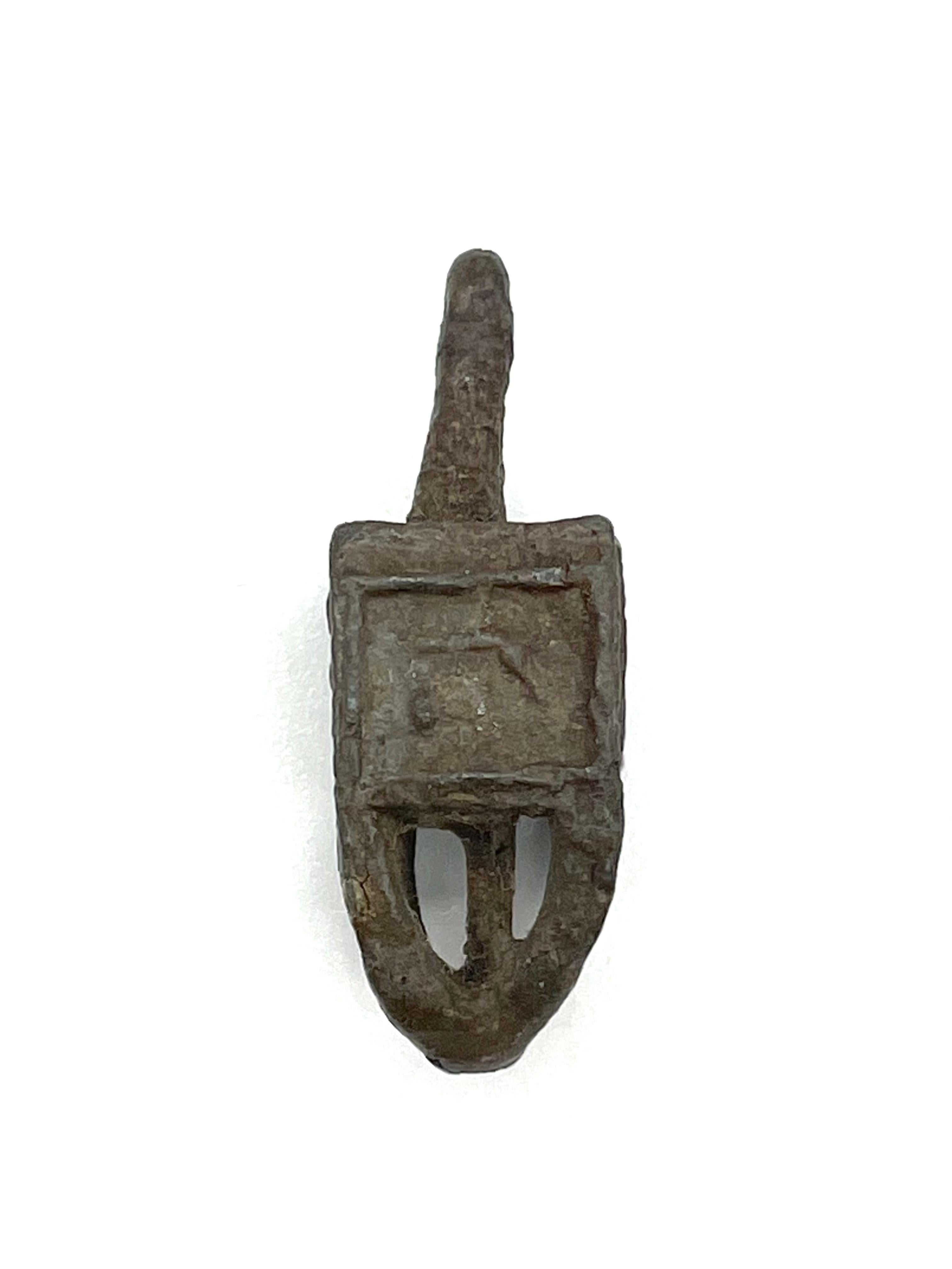 Cast lead Hanukkah dreidel, Poland, circa 1900. Found unearthed after roadwork construction began on Zgierska street in the city of Lodz during the 1950s. Square shaped Hebrew letters inside Star of David with overlay of dense grey cast. Distinctly