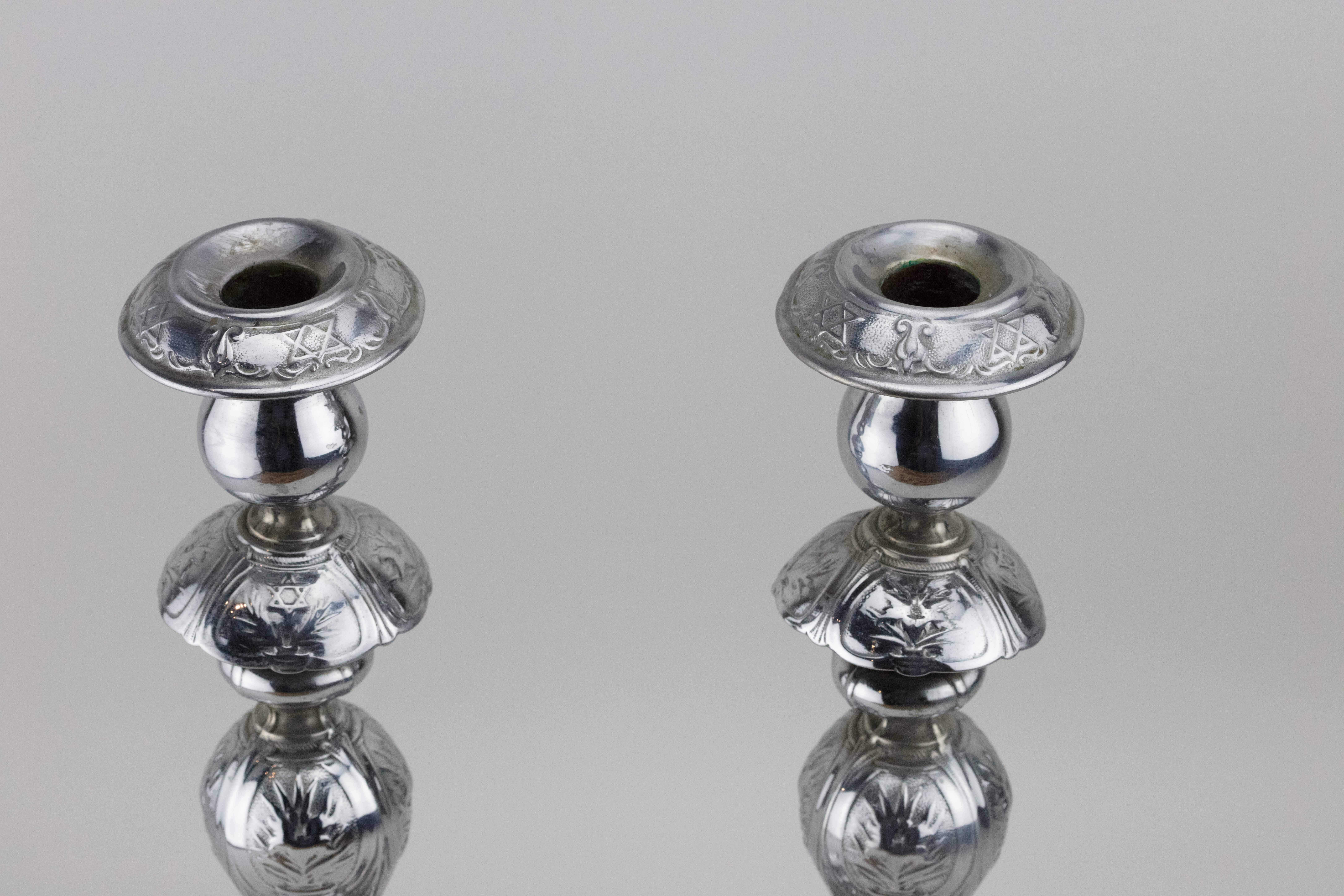 Rare pair of silver-plated brass Shabbat candlesticks, Warsaw, Poland, 1908.
These matching Shabbat candlesticks, impressed with flowers and Star of David, are the result of assembly-line production that was abundant in Warsaw during the end of the