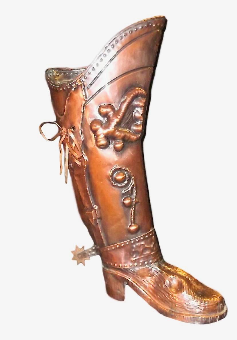 A gorgeous umbrella stand. Place this tall, elegant copper boot stand at your front door or in your hallway to catch loose canes and umbrellas. Made of copper metal. Crafted in Spain, circa 1920, the large shoe is in the shape of a musketeer boot.