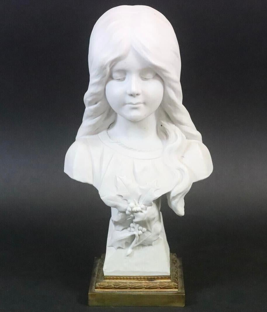Beautiful Art Nouveau white bisque porcelain girl bust with bronze fittings base. Bust of a girl with averted gaze and her hair tied up. Signed 