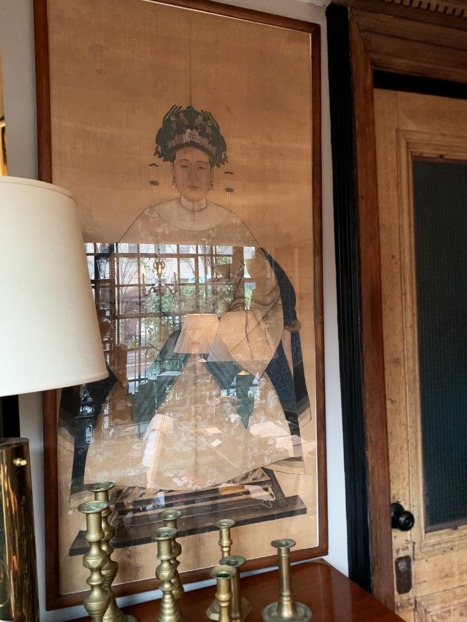 This diptych comprises of a pair of paintings on silk, with glass and wood frames, made 1900-1925. The paintings depict two Chinese dignitaries, poised and facing the viewer in stately attire. Their faces are beautifully rendered with subtle shading