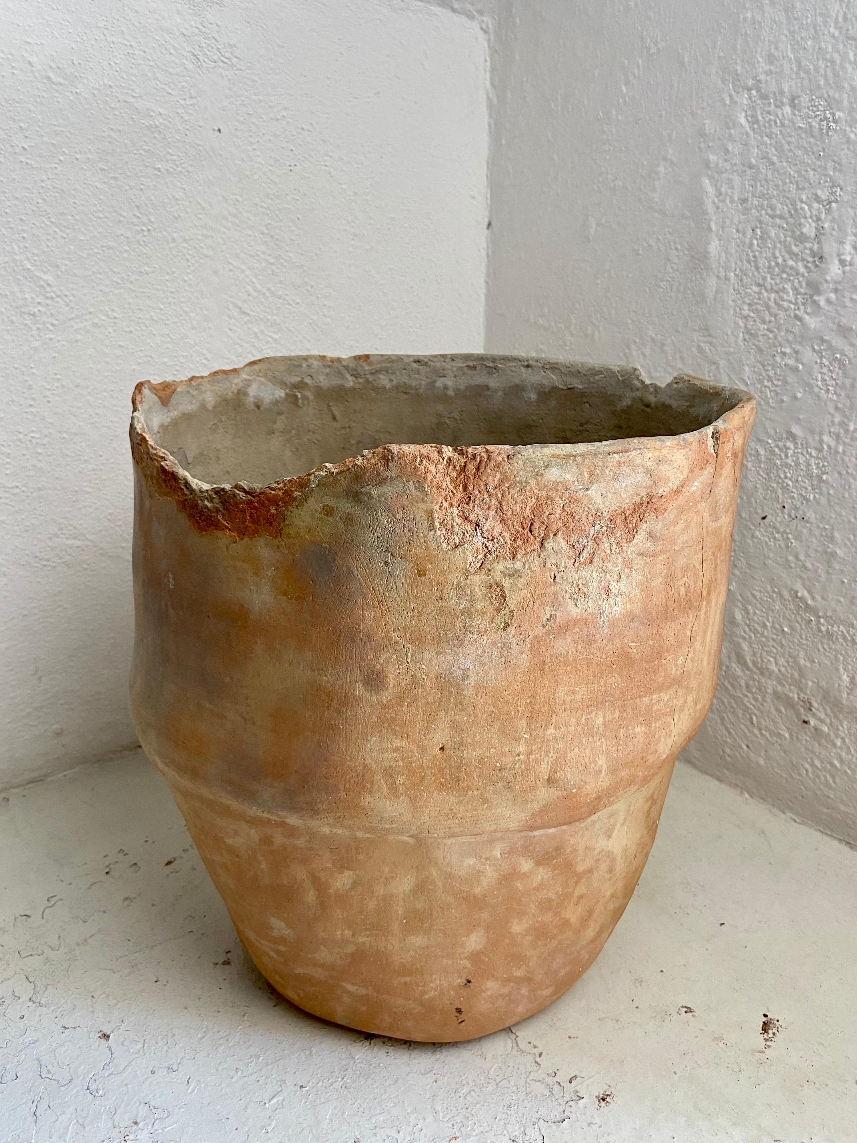 Early 20th century water pot from the bordering area of Oaxaca and Veracruz. These pots have their particular style of expanding in diameter half way up. The style also includes 2 small knobs on either side of the rim circumference. The rim on this
