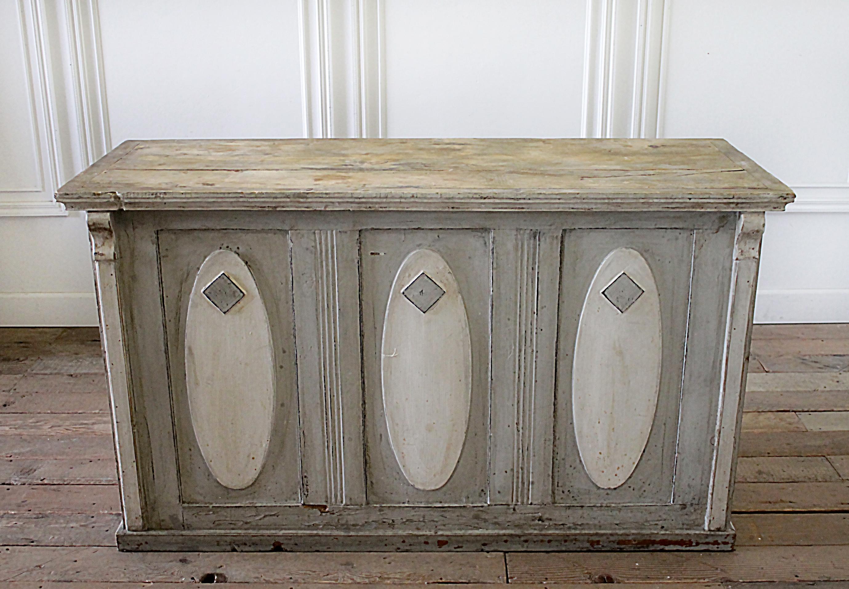 Early 20th century primitive counter server with marble top
Original painted patina in creams, grey, with slight colors peeking through. The paint is very shabby, distressed. The top wood has a seam or crack, but this is not structural. The top is