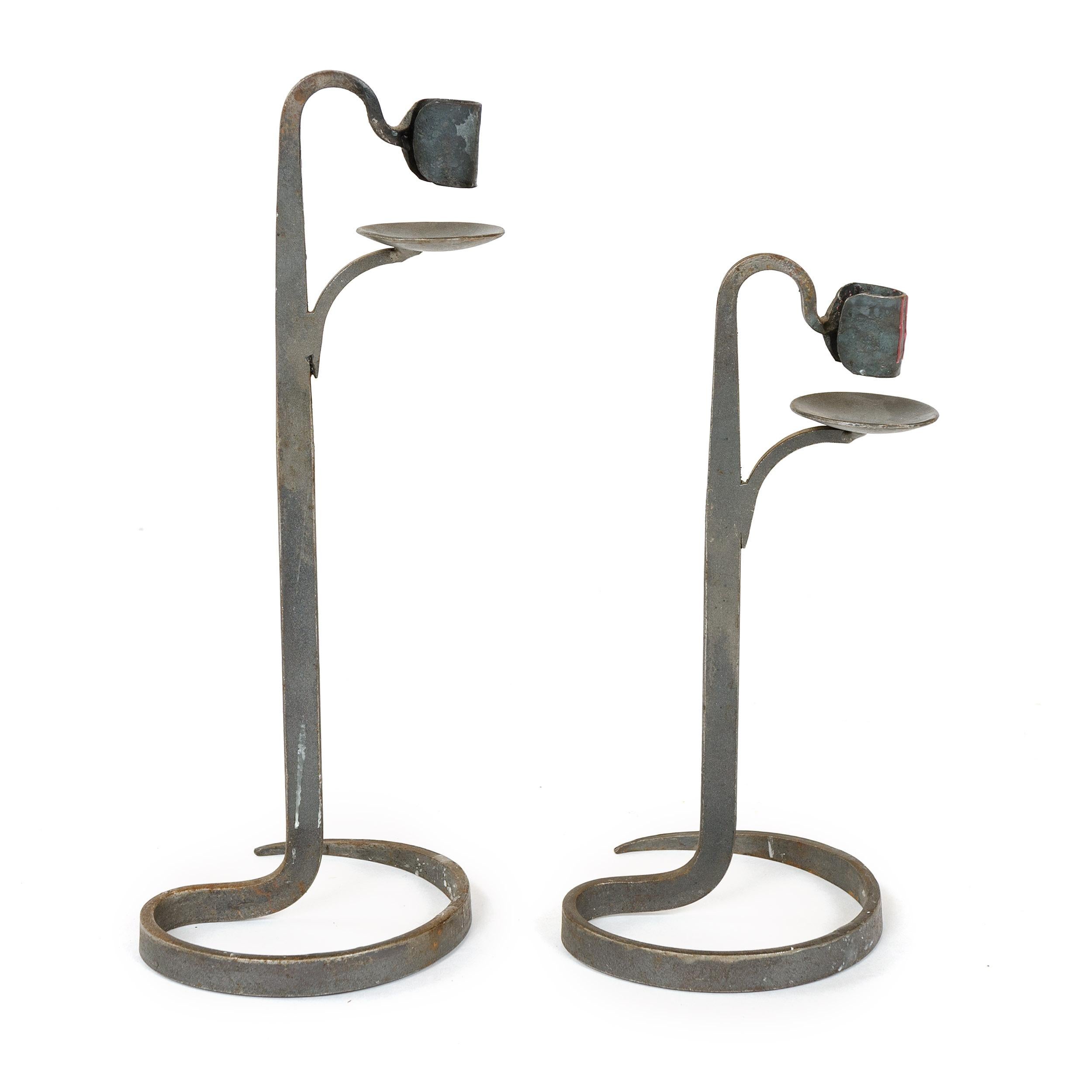 A pair of handwrought standing iron candleholders.