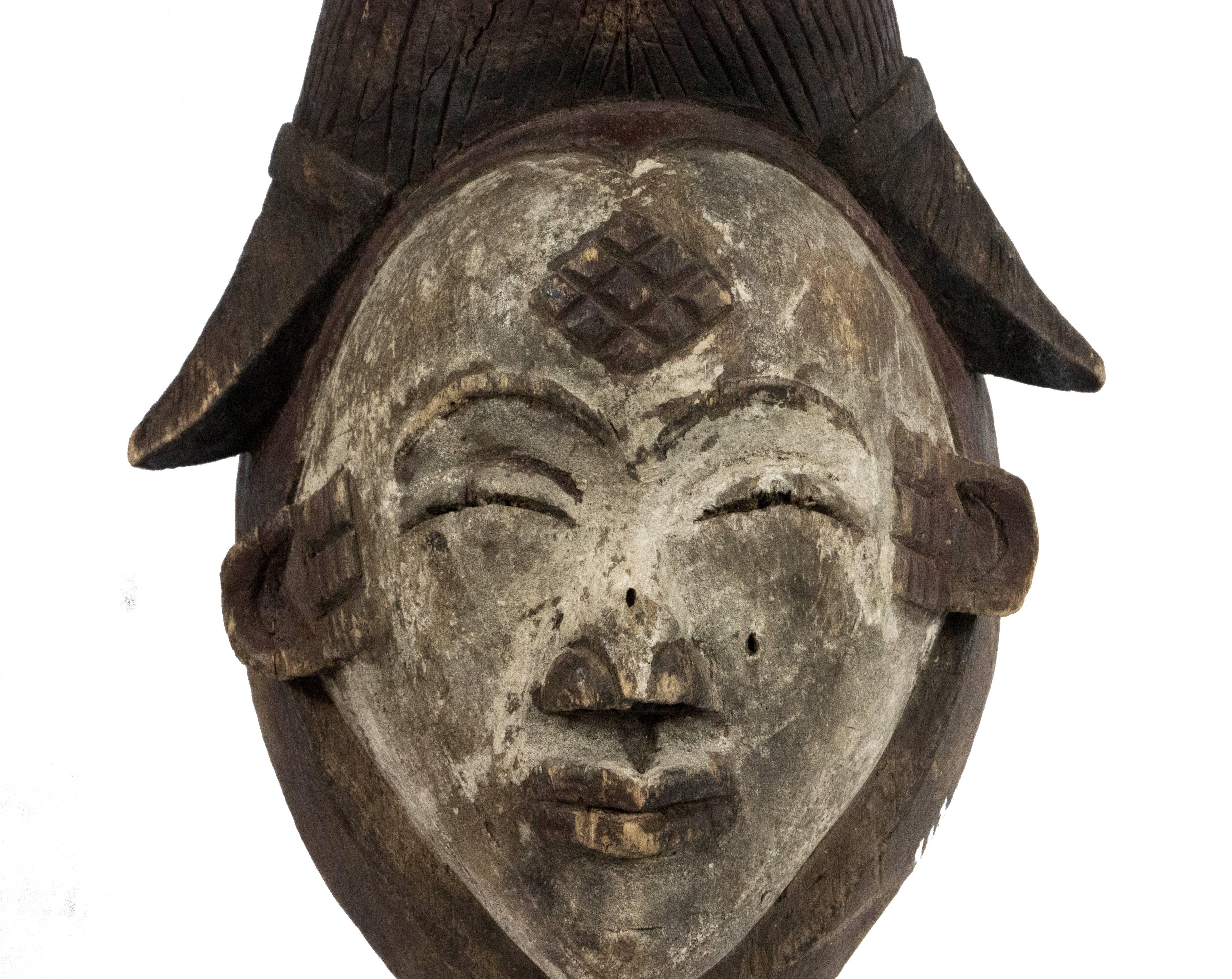 Punu mask; Gabon
Wood, pigment, kaolin
Dimensions: H 10 1/2 inches (26 cm)
Approximate age: 100 years (+/- 7) as confirmed by Museo d'Arte e Scieza in Milan based on their dendro-chronology tests results.
This Punu Mukudj mask represents an