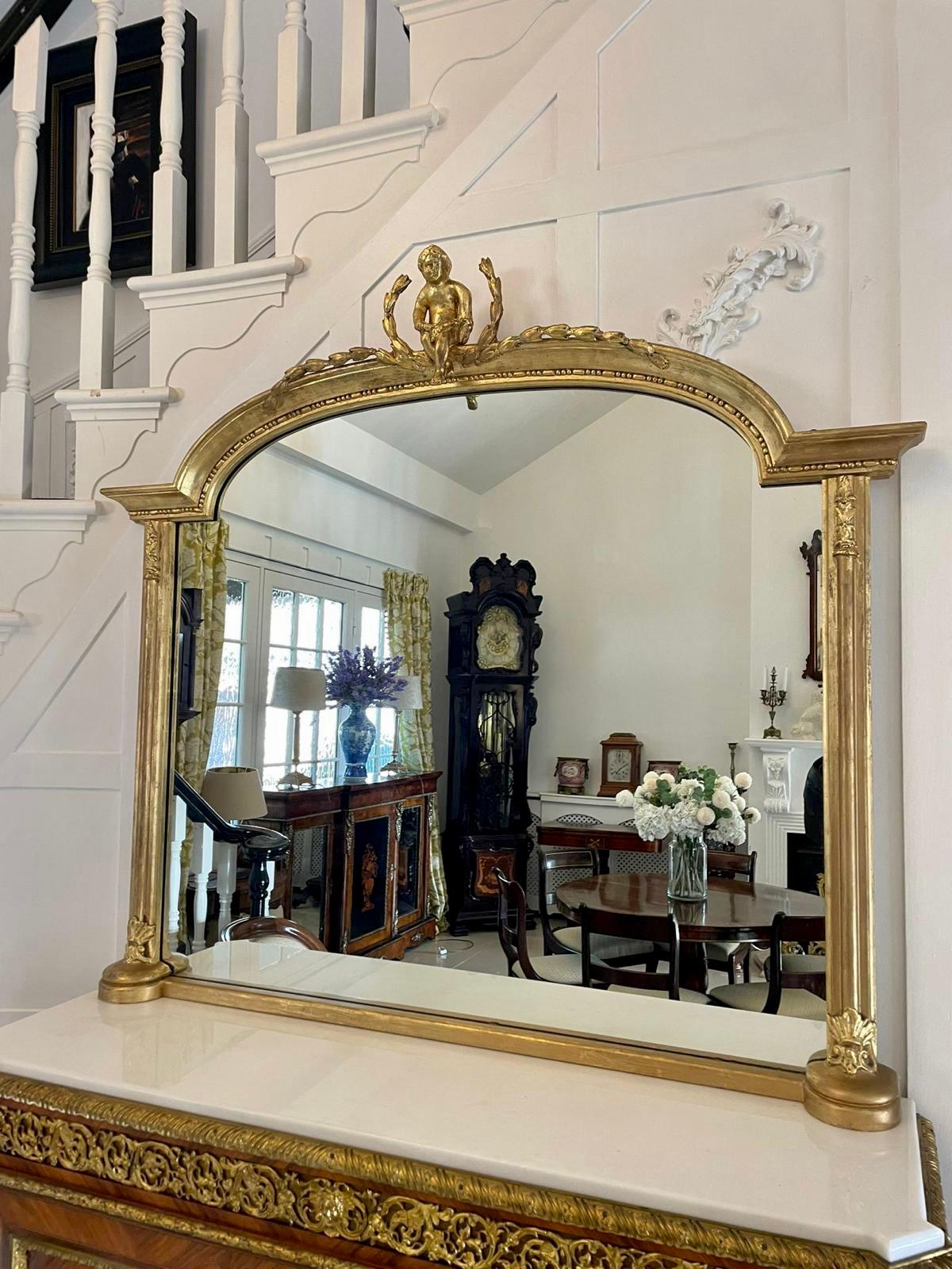 Early 20th Century large antique quality gilded wall mirror having a pretty shaped top with a quality carved cherub, original mirror plate and gilded and carved uprights 

An exquisite piece in beautiful original condition and of desirable