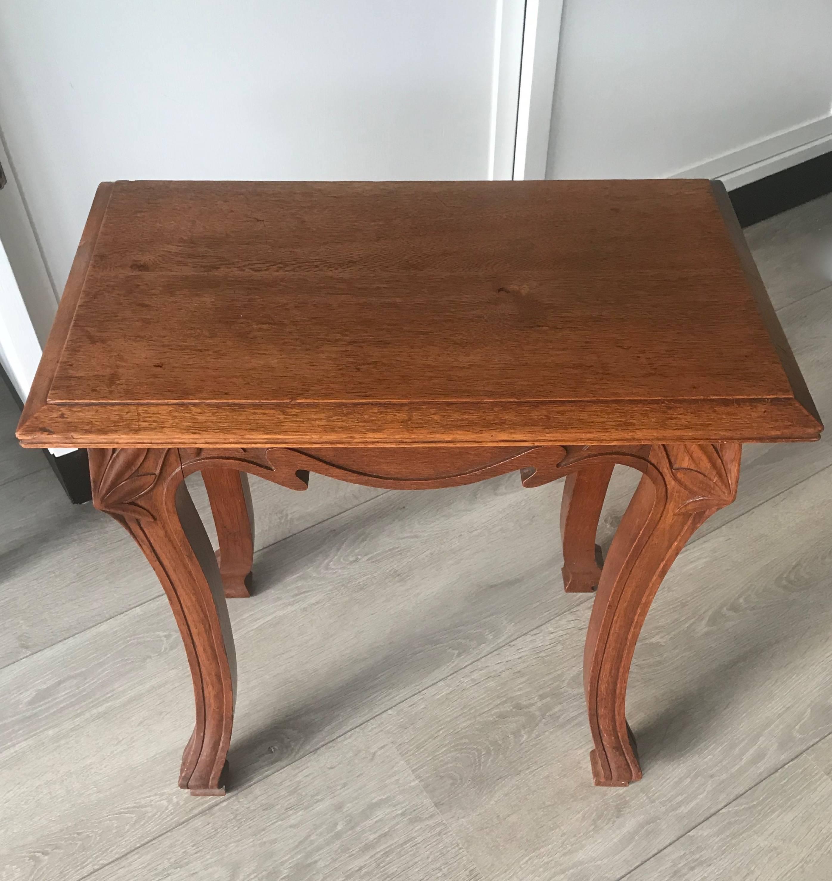 Highly stylish and practical oak table from circa 1900-1910. 

This rare and small Jugendstill table is as stabile as the day it was made and the woodwork is in excellent condition. The solid oak frame comes with quality carved Jugendstil elements