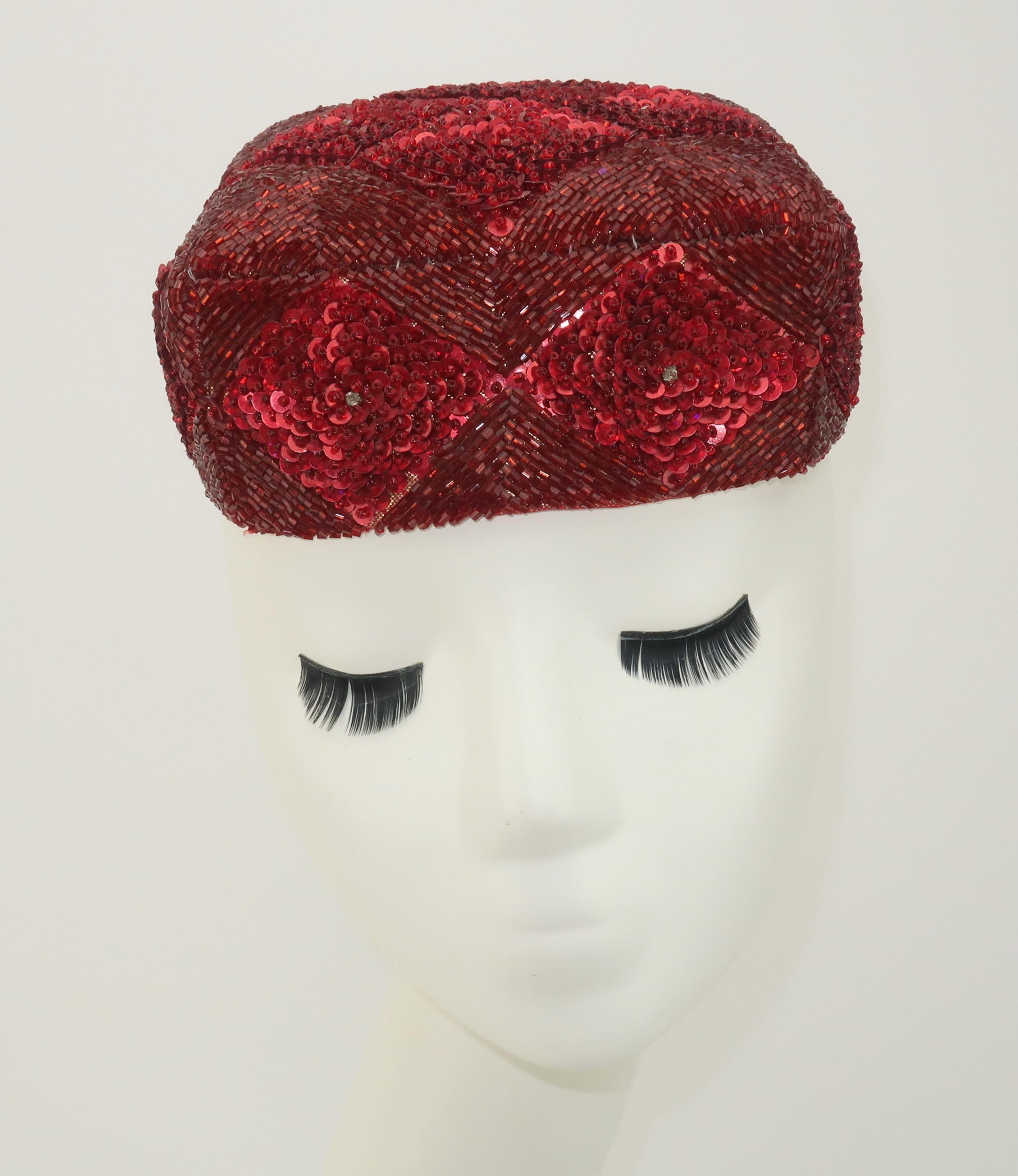 Early 20th Century Central Asian hat, possibly Uzbekistan or Turkmenistan, with an intricate geometric pattern of ruby red sequins and beads accented by crystals on silk.  The interior is lined with a quilted floral printed cotton.  From the estate