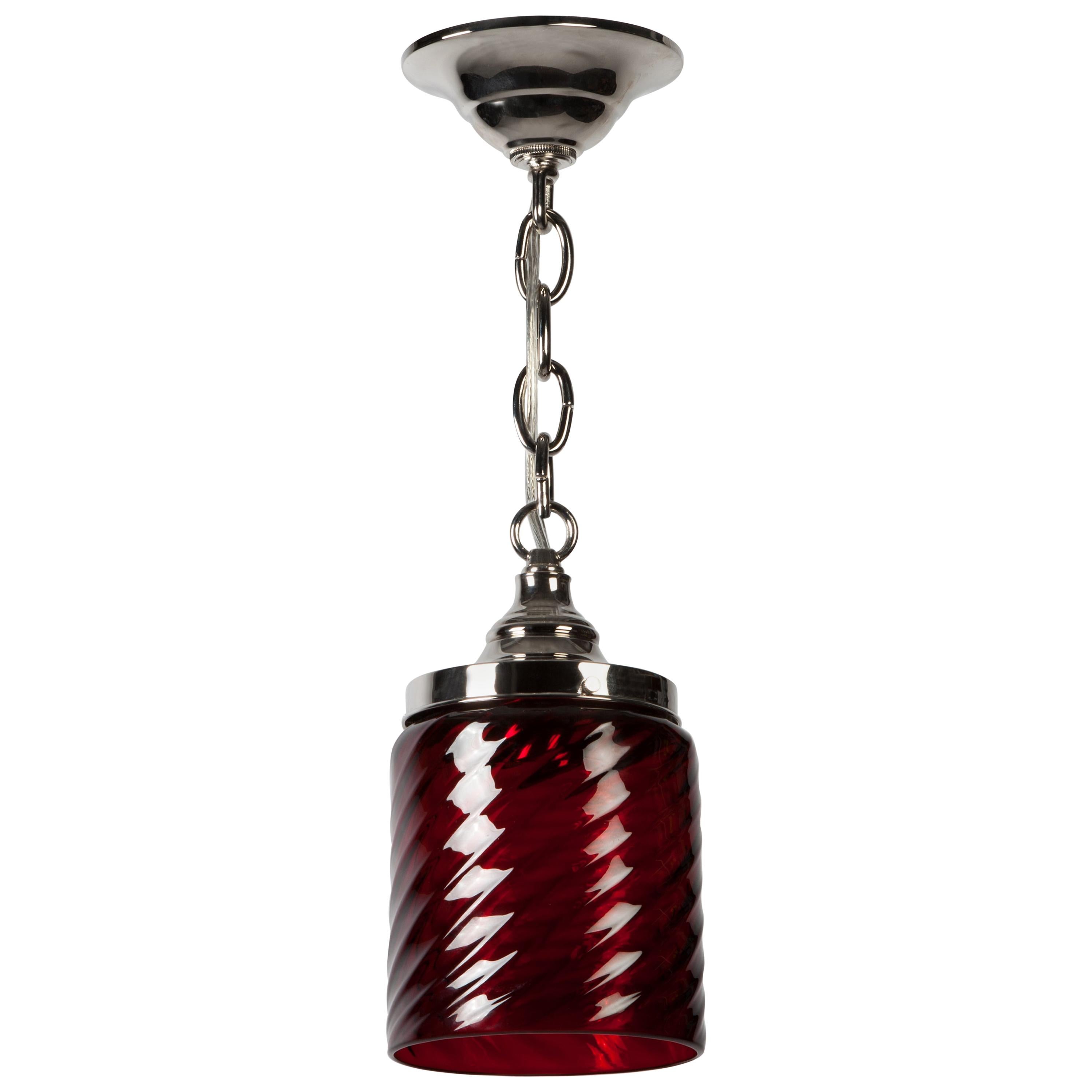 AHL3838
An antique hand blown, swirl patterned, red glass pendant on polished nickel fittings made in the Remains Lighting Co. workshop. Due to the antique nature of this fixture, there may be some nicks or imperfections in the