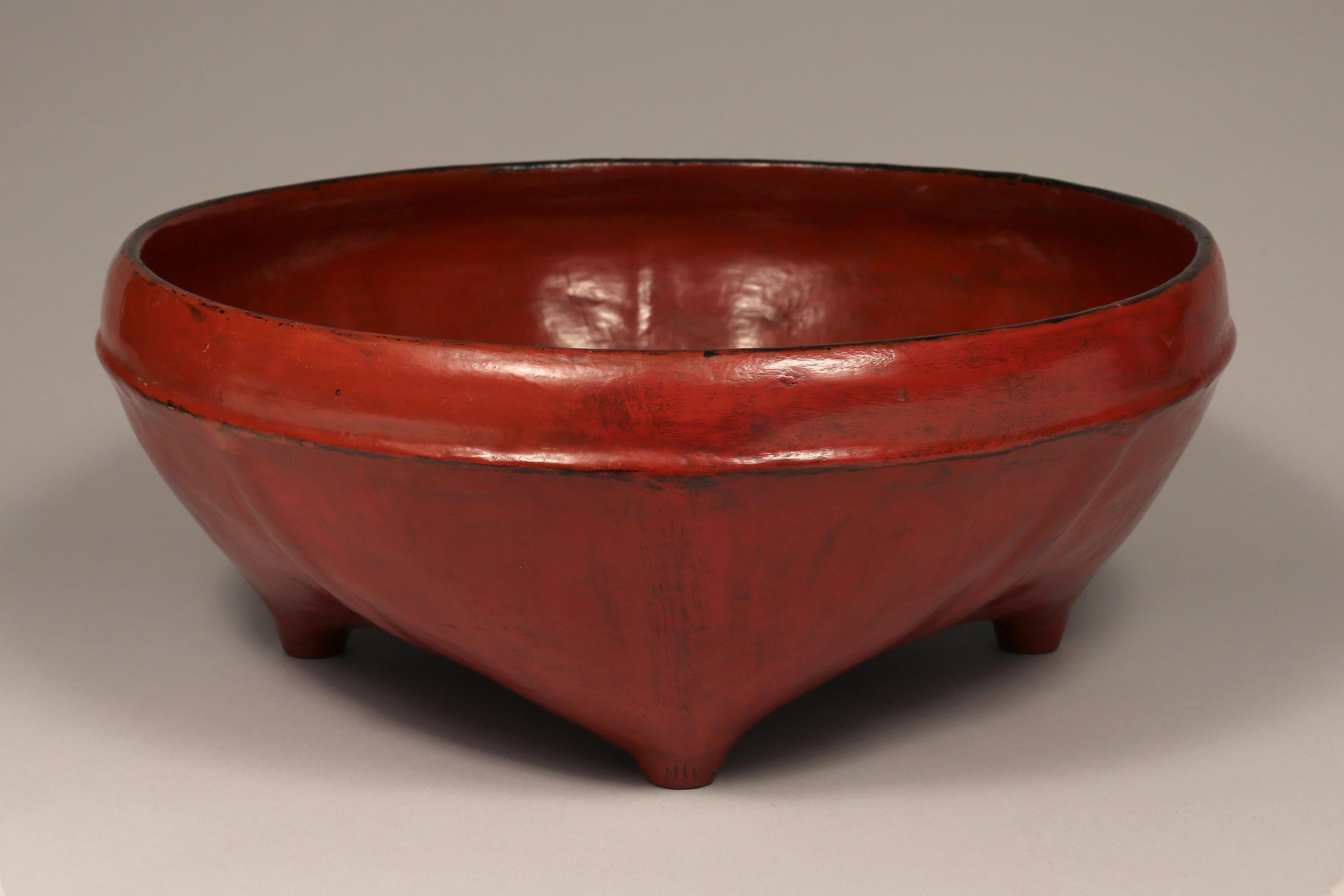 Burmese woven bamboo and red lacquered offering bowl, early 20th century

This lovely offering bowl features eight ribs and four feet.
Woven bamboo is lacquered in layers - first black, then red achieving the distinctive look of Burmese