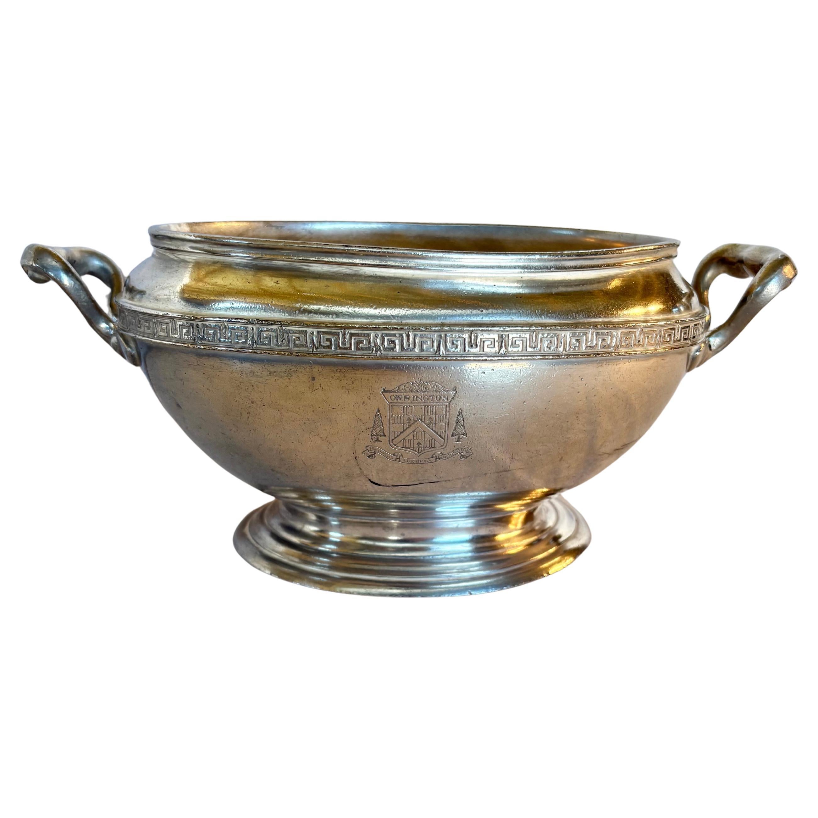 This Early 20th Century Orrington Hotel Silver Silverplate Tureen was crafted in the early 1900's. The piece features an oval design with two scroll side handles. The tureen is hallmarked on the side with an emblem reading Orrington and on the