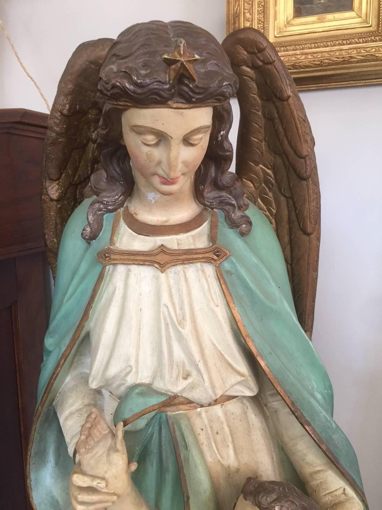 Early 20th century Religious white terracotta Gabriel angel statue from a church.
Angel Gabriel with his wings protecting a child.
Painted terracotta.
Original patina.