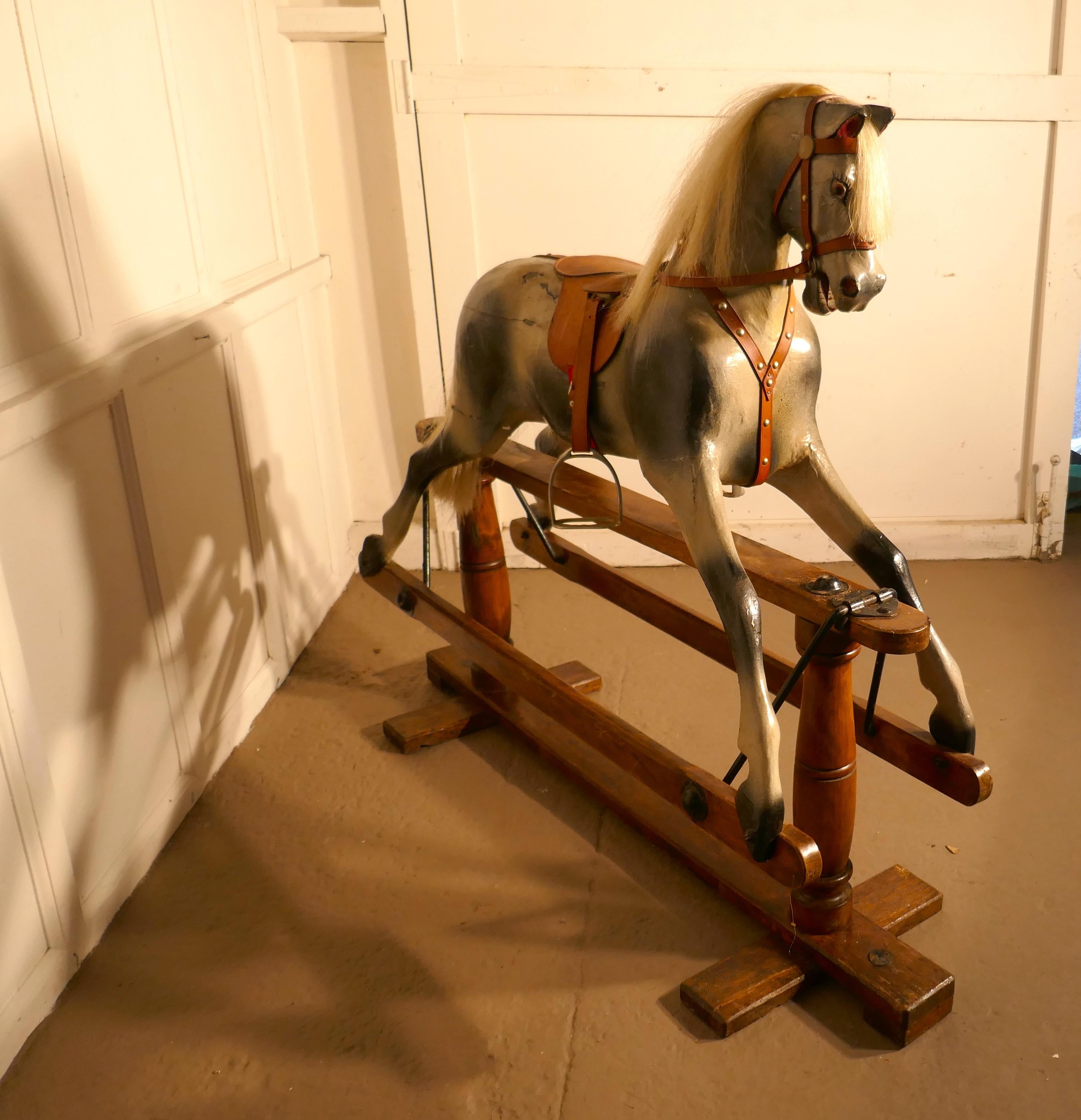 Early 20th century rocking horse by Lines Brothers

A handsome Dapple Grey galloper with Horse Hair mane and tail, he has the Classic open mouthed expression and bright glass eyes
Our Handsome galloper has had some minor restoration, (to keep him