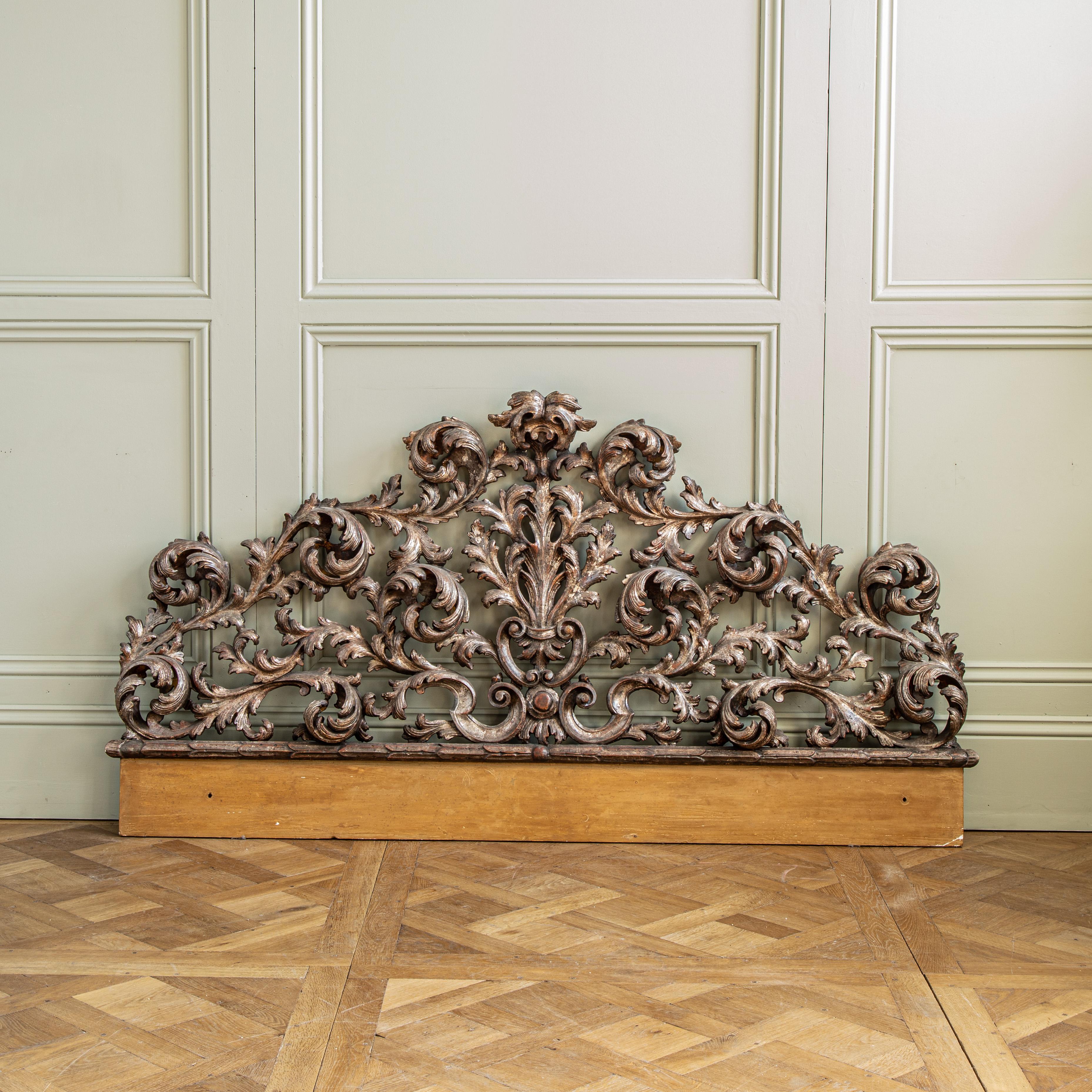 This elegant Antique Rococo Headboard is the perfect centrepiece for a classic bedroom. Crafted in Italy during the 1900s, this headboard boasts a timeless Rococo style.
We can make bespoke upholstered panel to integrate the carved piece and finish