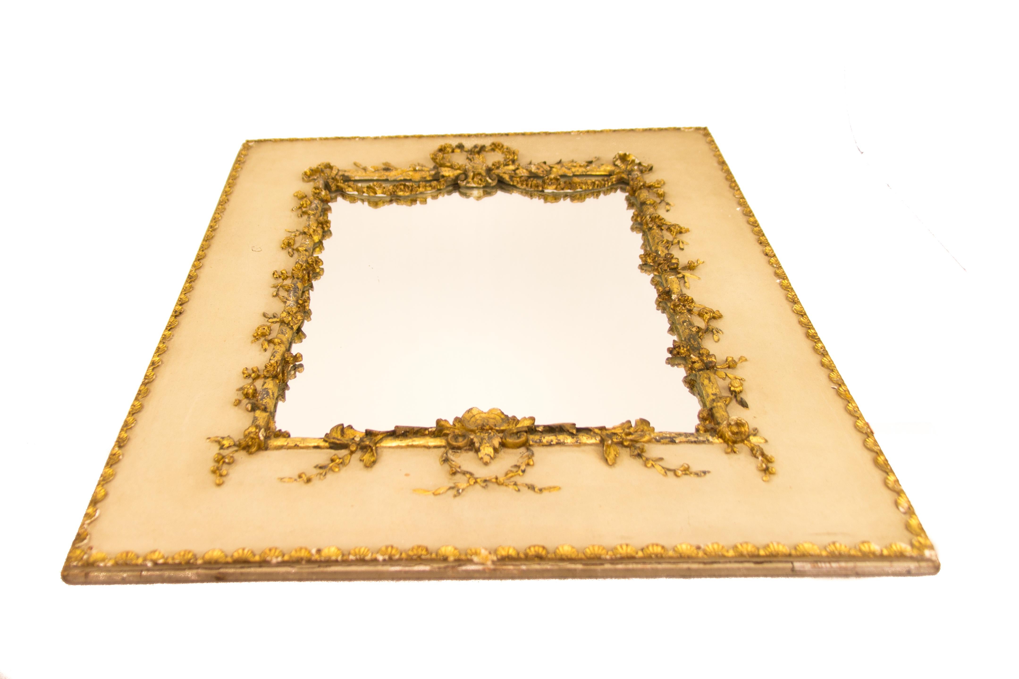 This exquisite antique trumeau Rococo or Louis XV style picture or mirror frame on white painted wooden panel is decorated with golden garlands of flowers and leaves, perimeter decorated with small golden shell ornaments. The frame has a newly