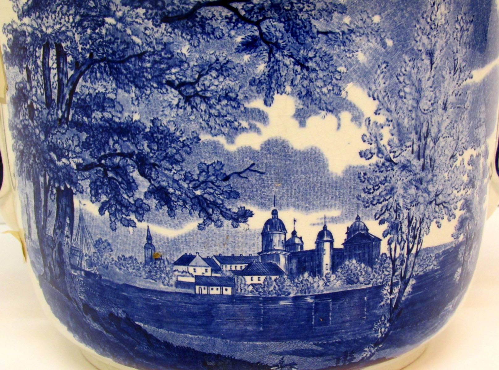 Early 20th century Swedish Pottery Jardinière by Rorstrand with scrolled handles and decorated with a blue and white pastoral scene.