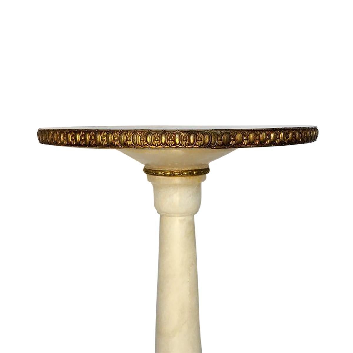 Small round alabaster marble drinks spot table with decorative brass and gold metal detailing. This small accent occasional side or end table features a neoclassical style pedestal column base, circa early 20th century, Italy.
  