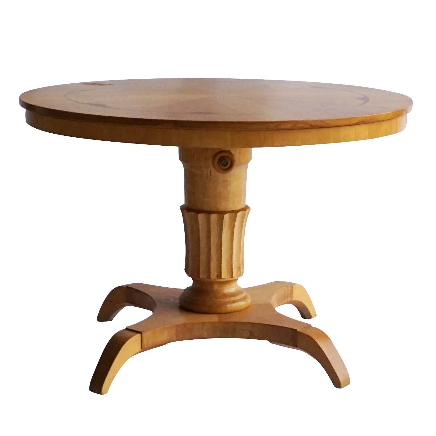 A vintage Mid-Century Modern Swedish round pedestal table or coffee table made of hand carved Birchwood with a nicely carved baluster column, standing on four curved legs, in good condition. Wear consistent with age and use, circa 1940, Stockholm,