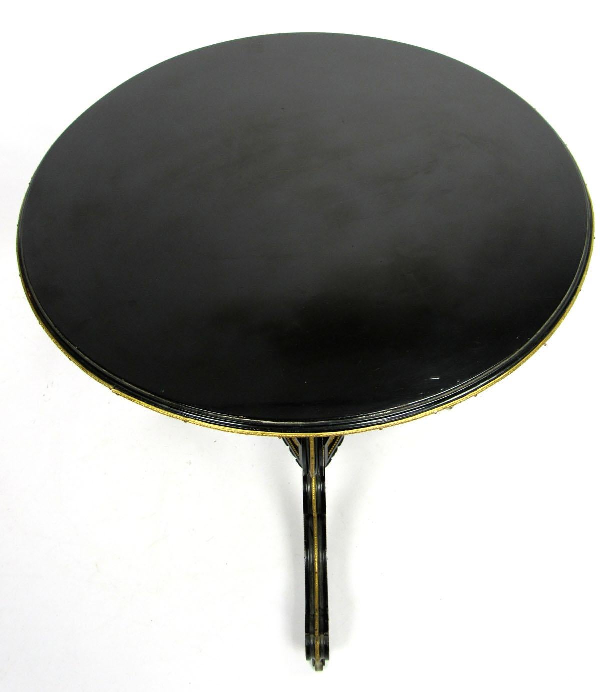 Early 20th century Continental black lacquered side table with gilt metal detail, from a fine Dallas estate.