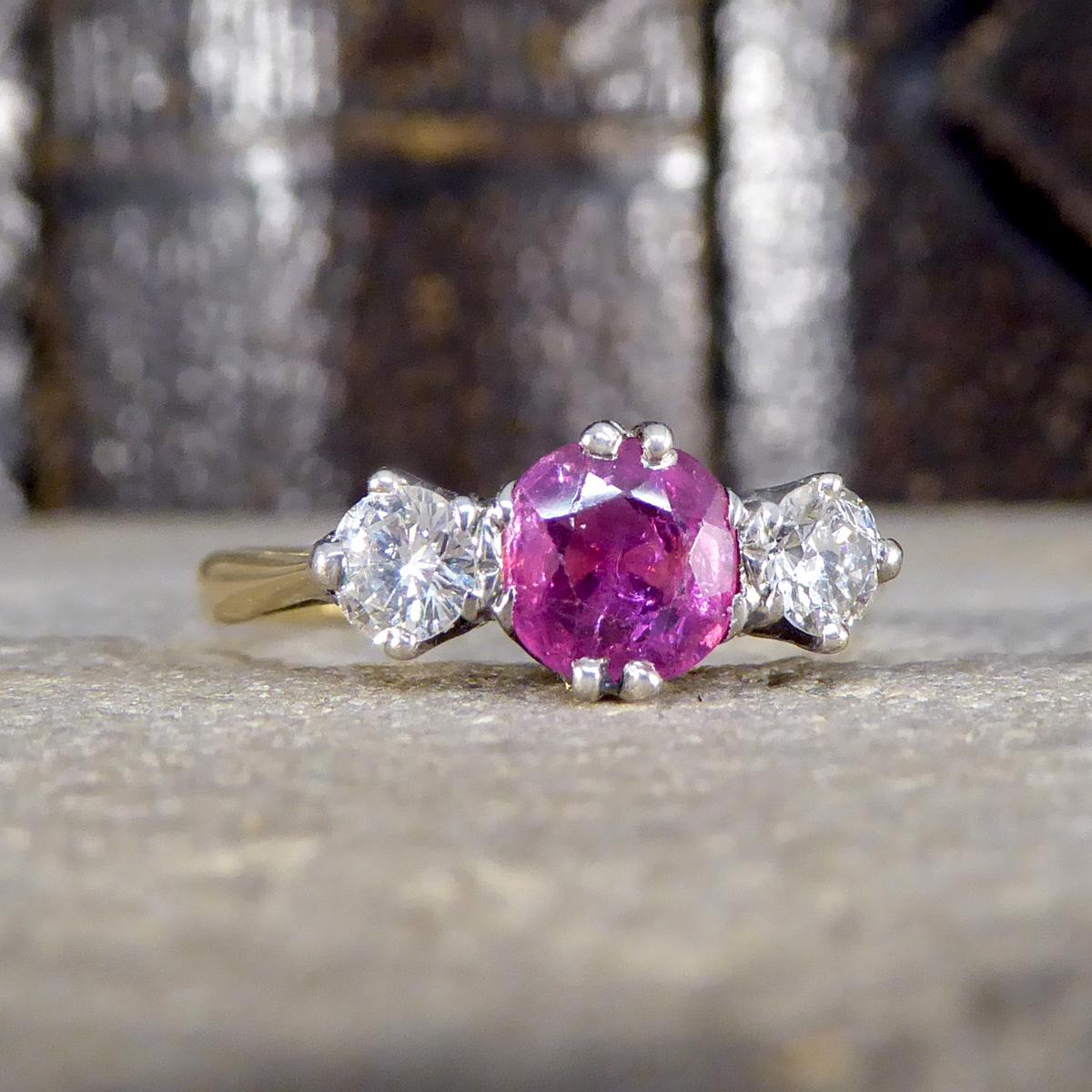 This exquisite early 20th century Ruby and Diamond three stone ring showcases the timeless elegance and craftsmanship of the era. Set in luxurious 18ct yellow gold and platinum, the ring features a beautifully balanced design that exudes