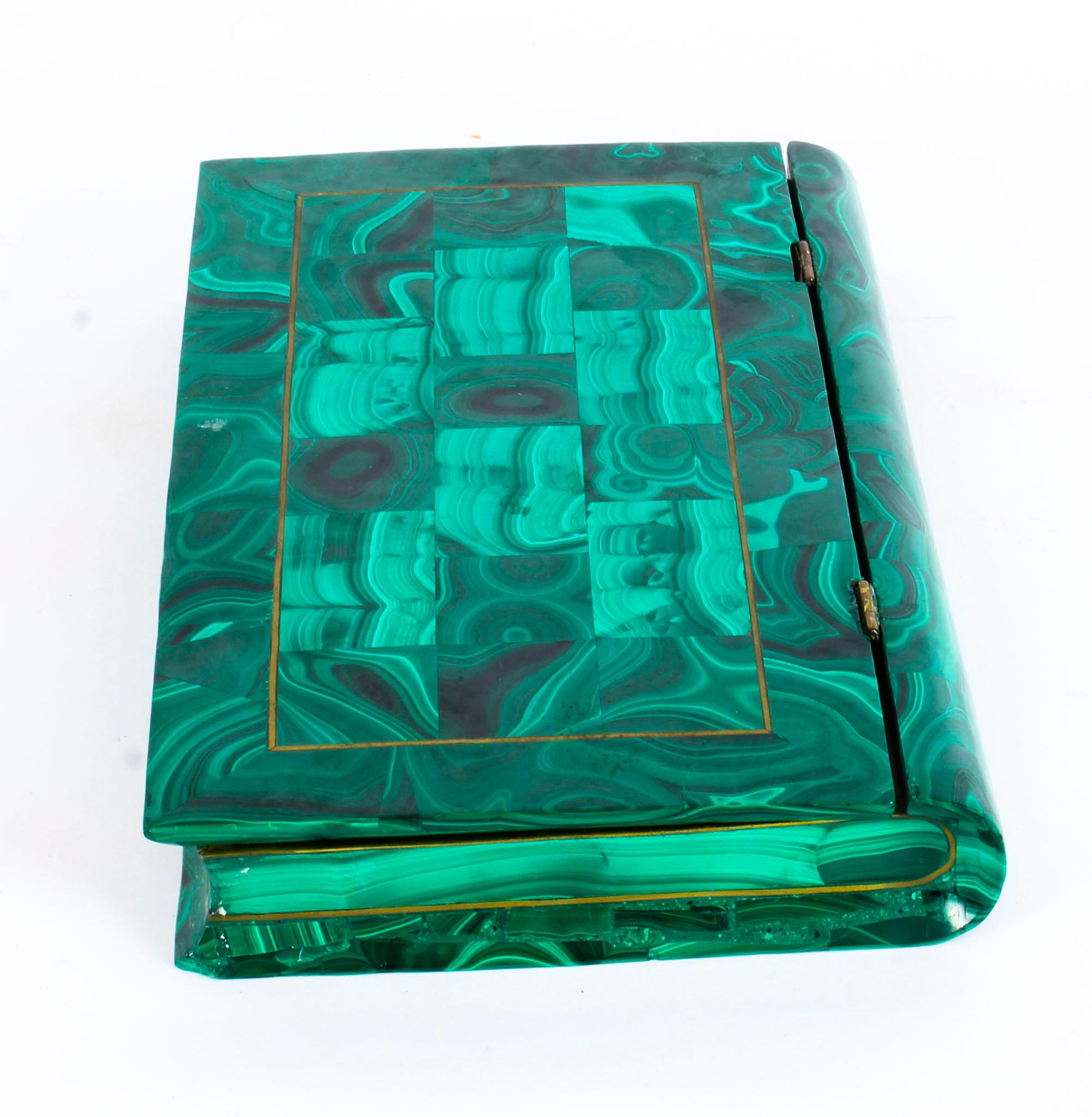 This is a superb quality Russian antique malachite book form jewel box, circa 1900 in date, later converted to display a quantity of mineral specimens.

The rectangular hinged lid features malachite parquetry with decorative brass stringing. It