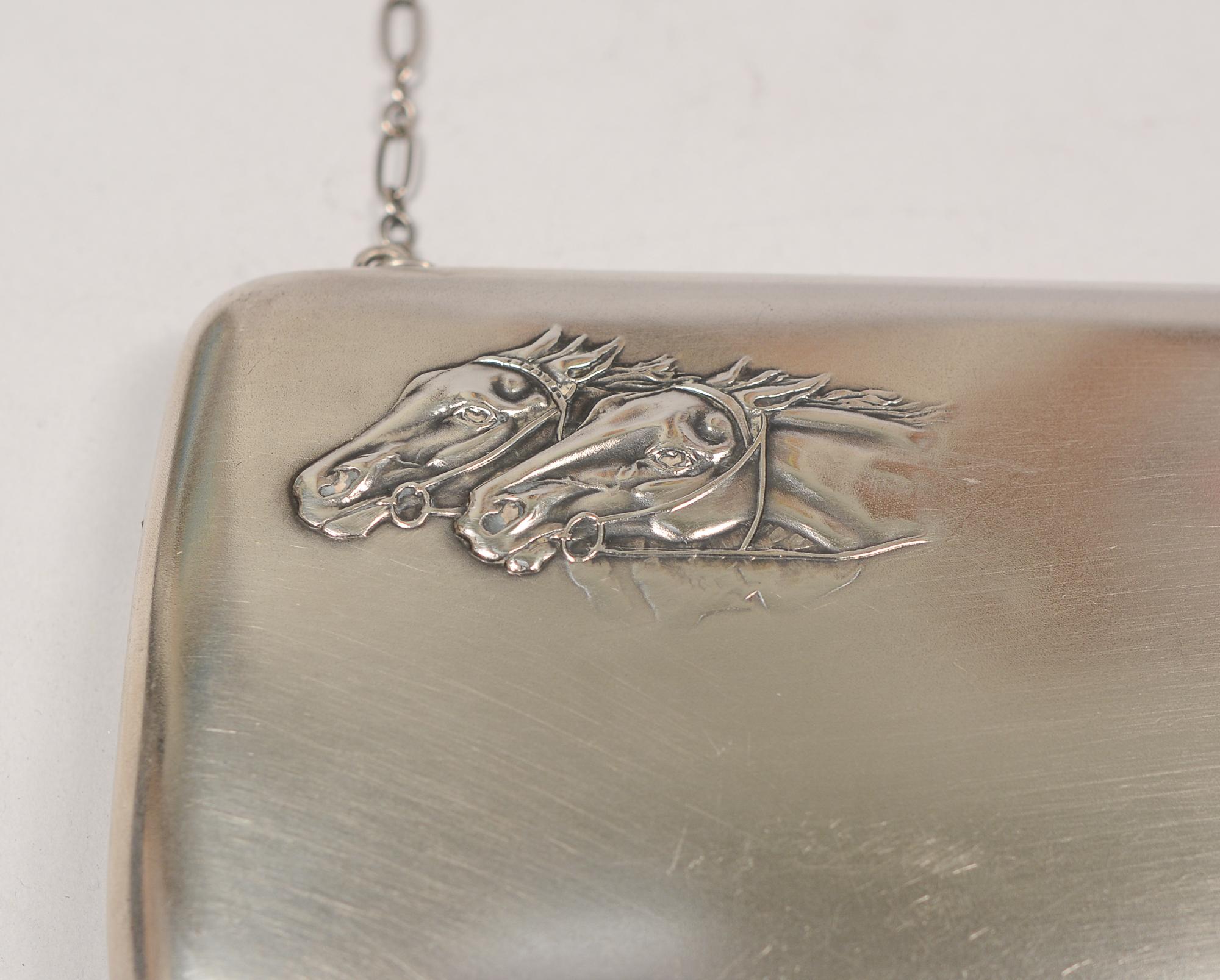 Russian silver clutch or evening purse. This has repousse horse heads with outstanding detail in the left corner. The clutch is .875 fine silver. There is a glass cabochon for the clasp. This was made by the 2nd Artel in Moscow about 1912 to 1916.