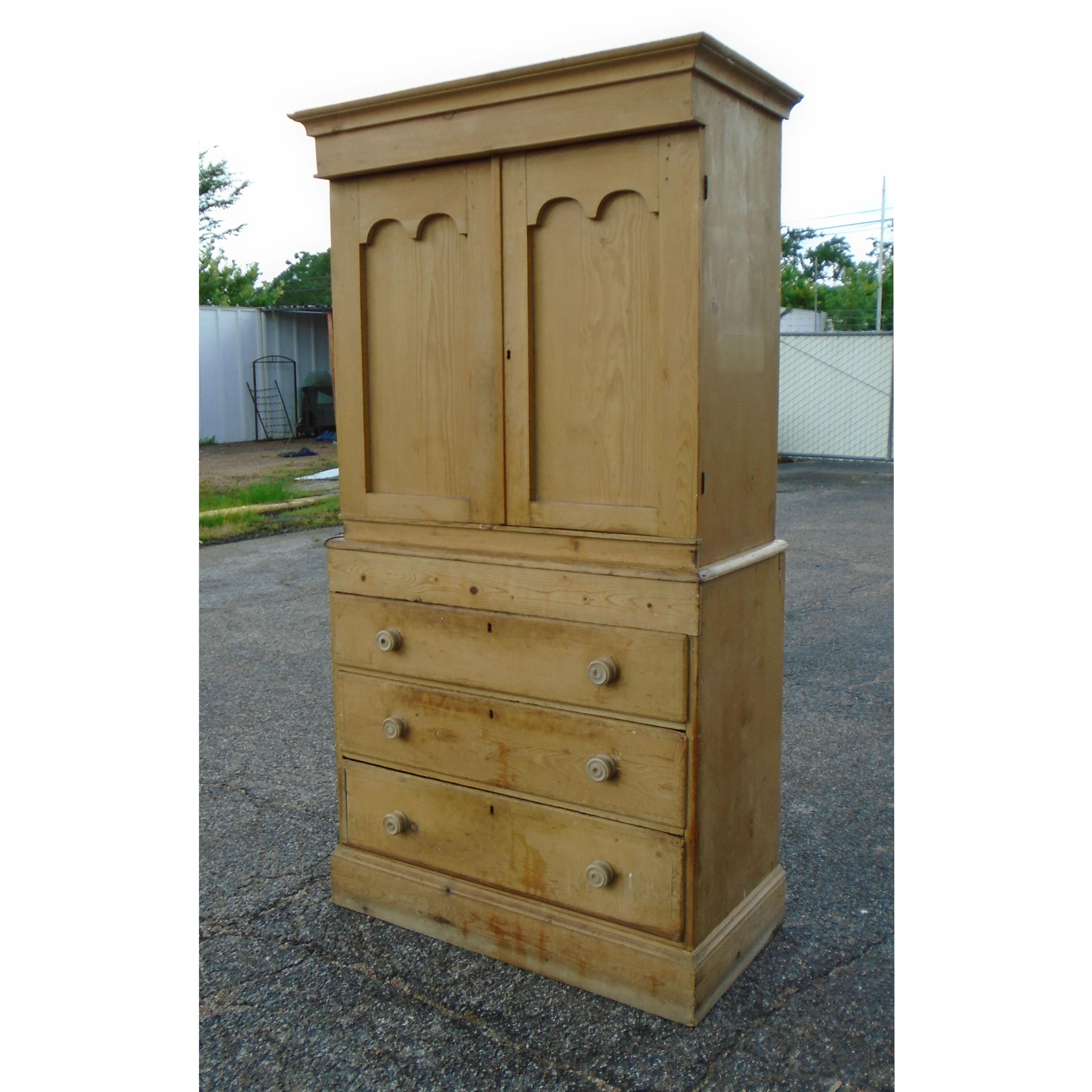 Rustic antique pine cupboard

Tall natural 2-piece rustic cupboard cabinet with top section opening to shelving 
with three drawers below. Pine pulls.

  