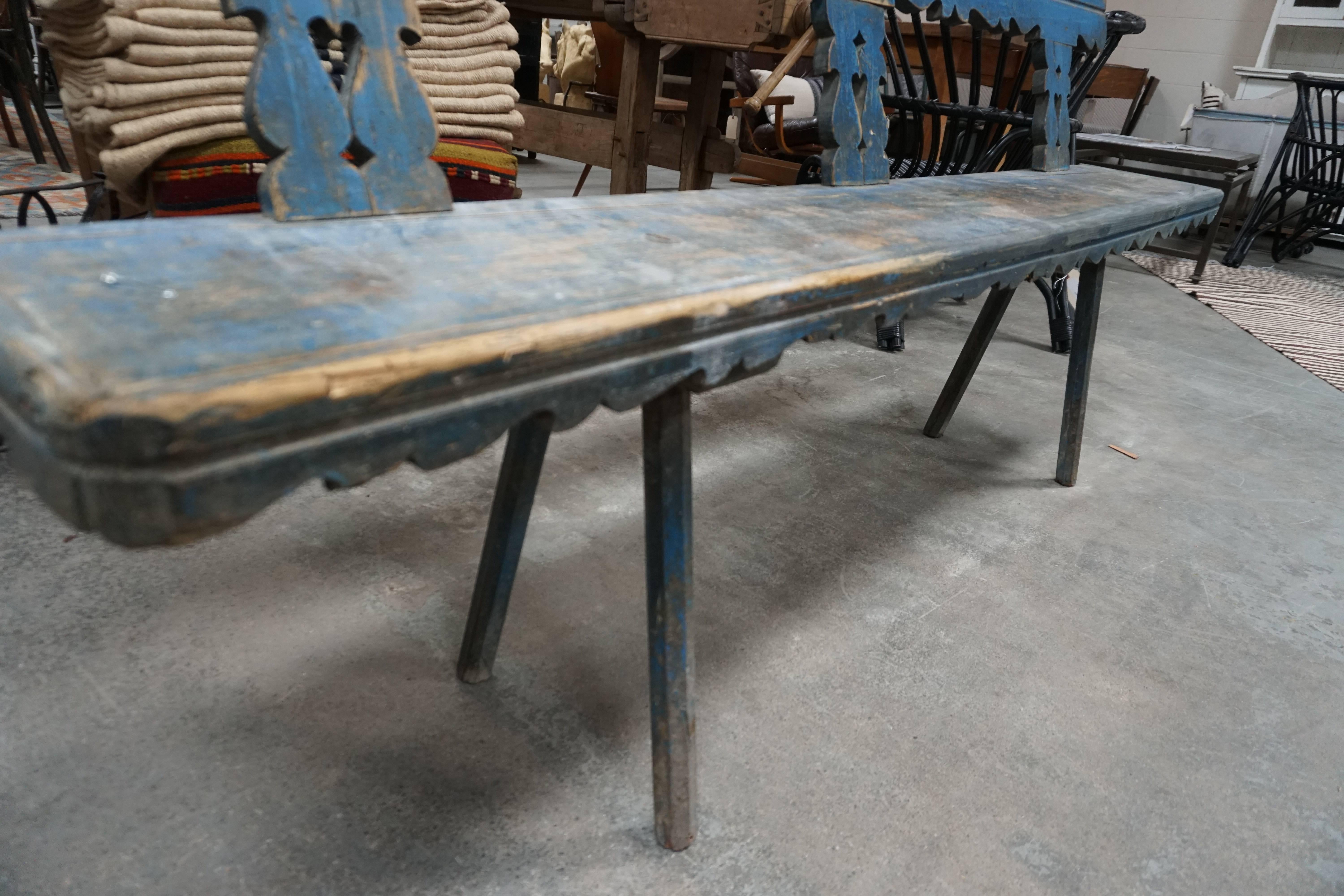 This French farmhouse bench dates from the early 1900s. The scalloped toprail and seat apron add charm to this rustic piece. Legs are hand-carved, and the entire piece is hand-painted a vibrant blue. 
Measure: Seat height 19.75