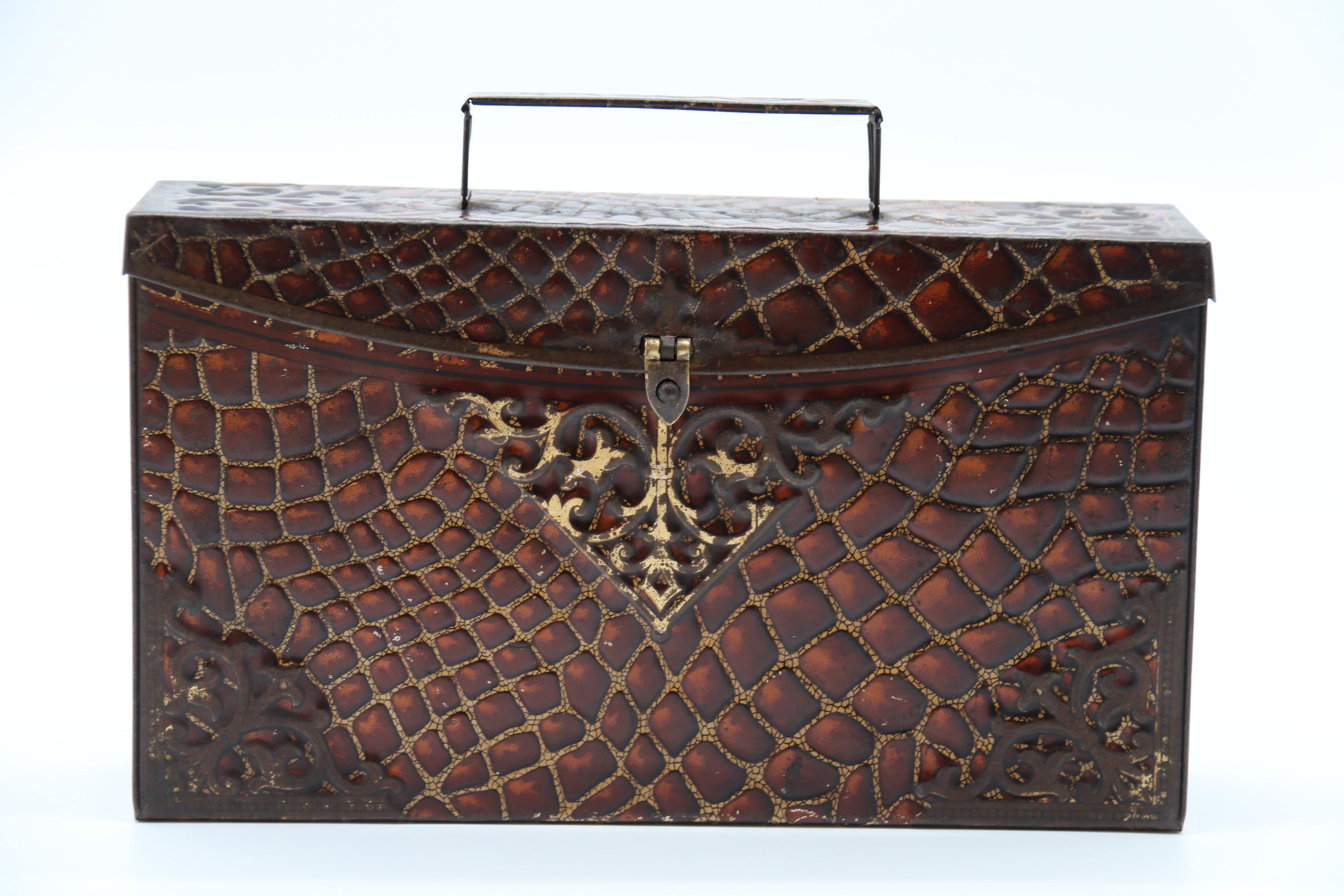 A rare example of a novelty biscuit tin in the form of an elaborate crocodile skin and brass mounted satchel was produced by Peek Frean and Co of London circa 1900 who were biscuit manufacturers. 

Height 15.5 cm x width 22cm x depth 5.5cm