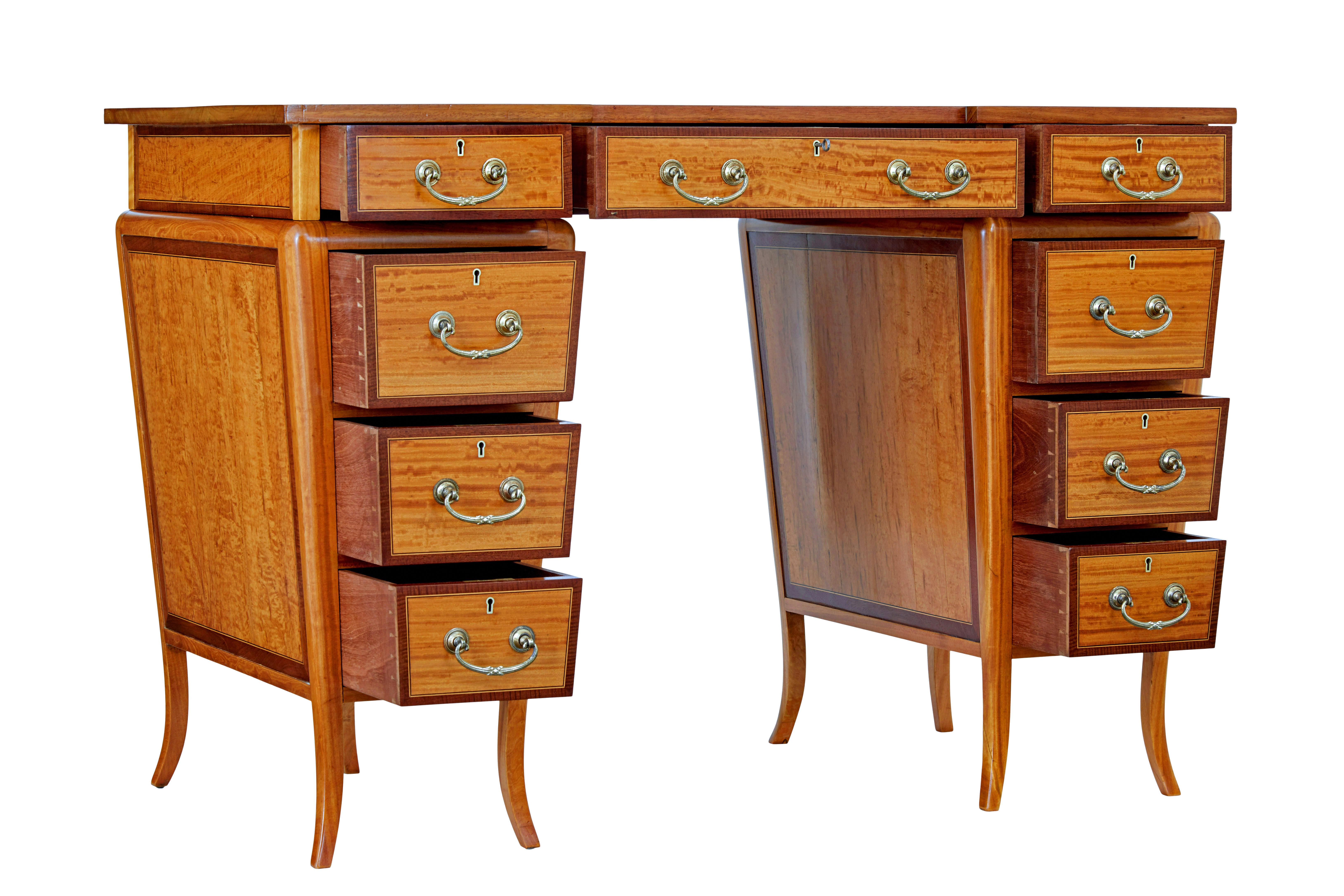 Early 20th century satinwood sheraton revival desk circa 1910.

Fine quality petit sheraton revival pedestal desk, comprising of 3 sections, top surface and 2 pedestals.

Shaped top with a inset deep red leather writing surface, decorated with gold
