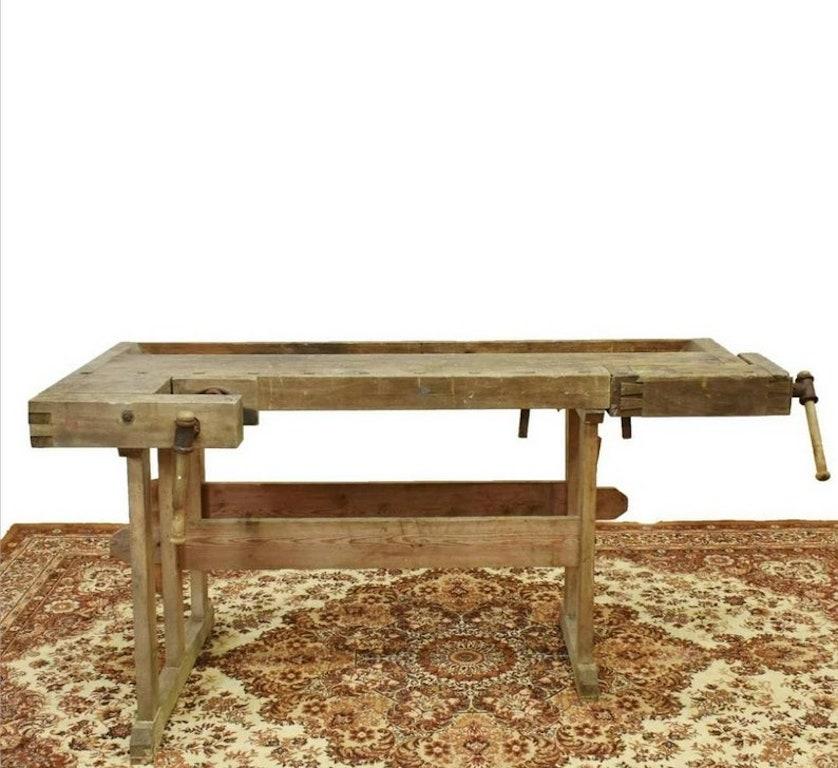 An antique industrial Scandinavian, likely Danish, pine carpenters and craftsmans work bench. Born in the early 1900s, having a distressed weathered finish, full of character, rustic charm and an outstanding patina from over a century of use.
