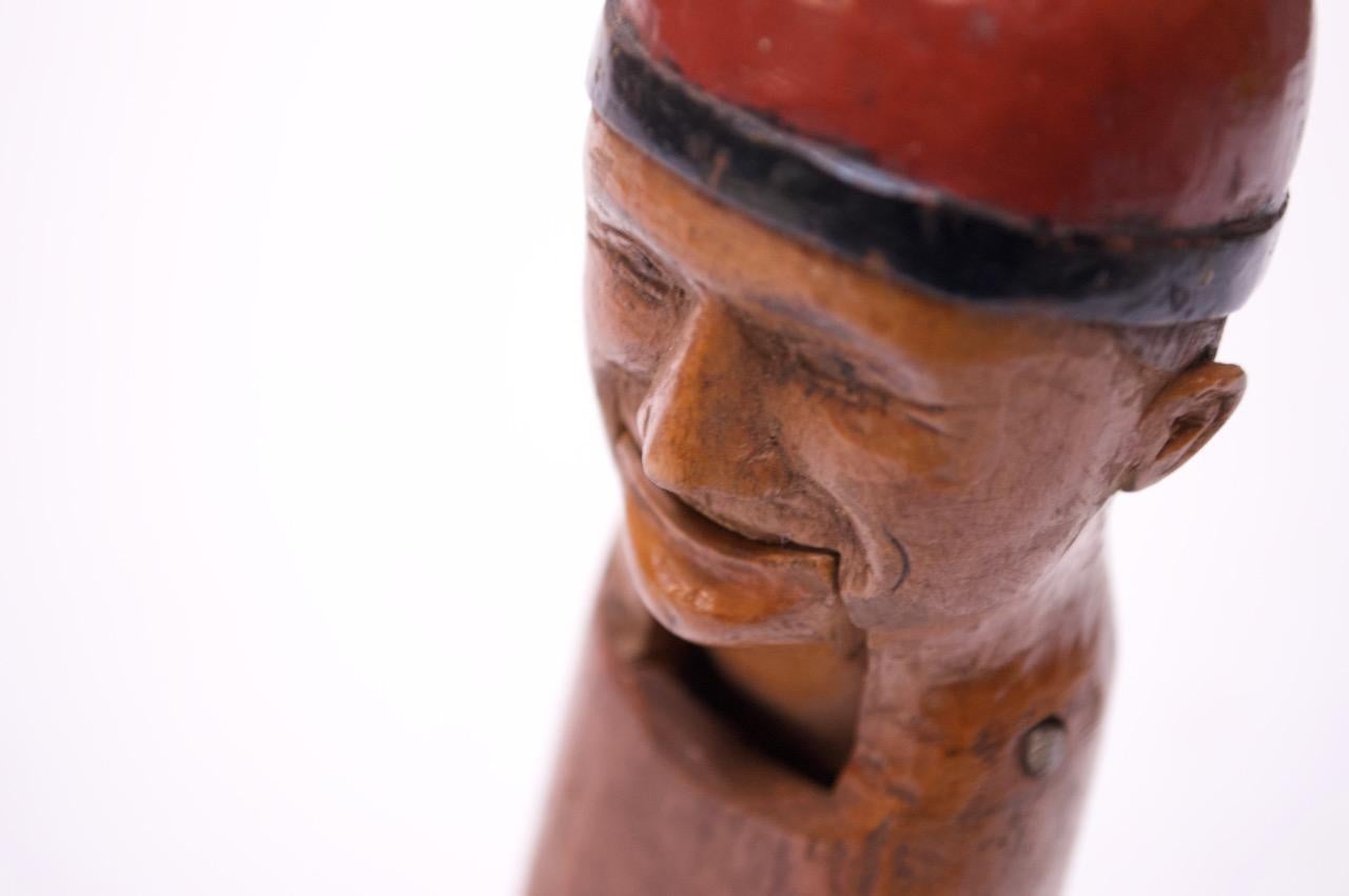 Scandinavian Folk Art nutcracker with man in cap decoration, circa 1920-1930s. Fine expressive facial and lovely hand painted details. Very nice, vintage condition with light wear consistent with age / use.
  