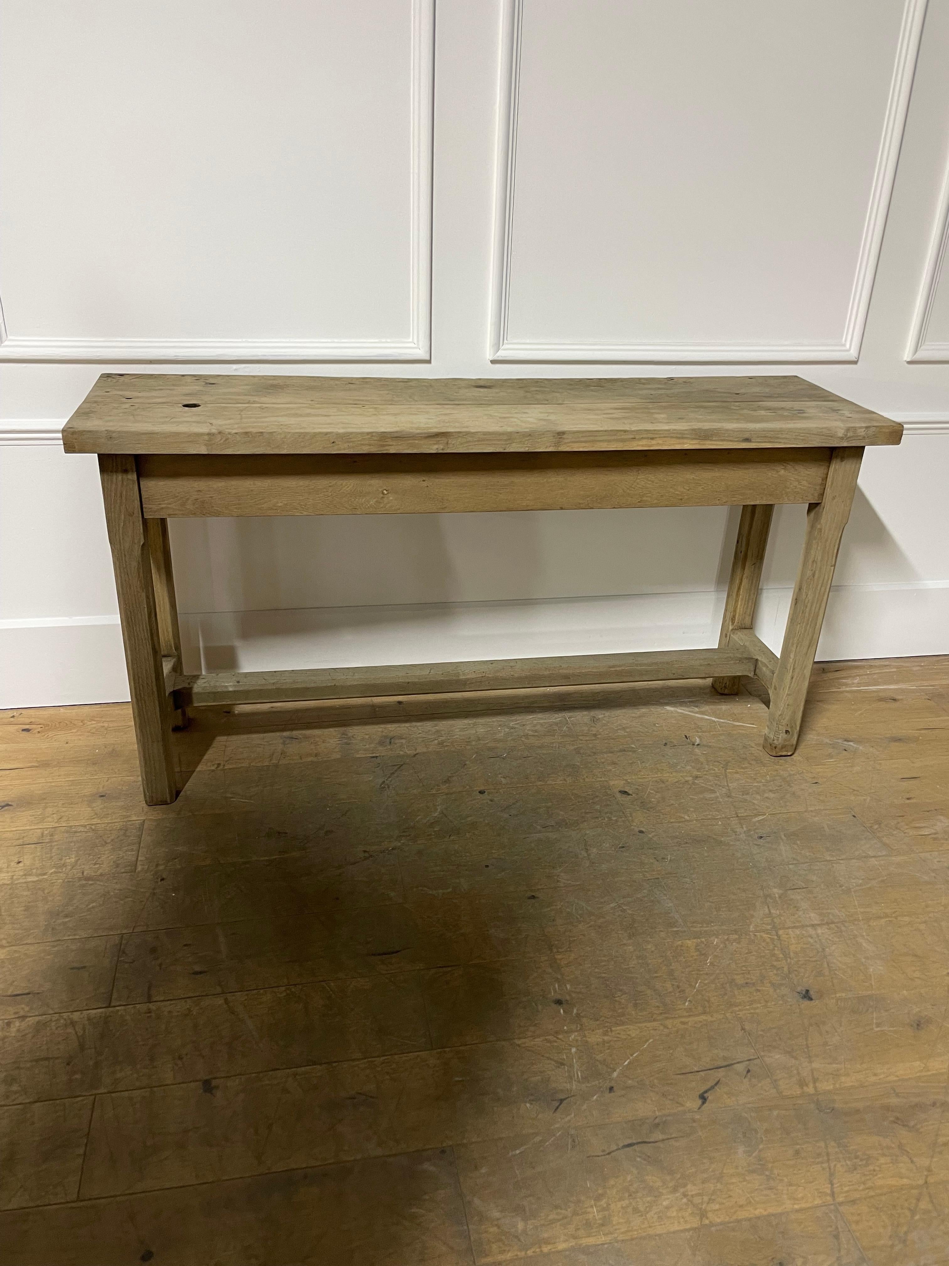 Very stylish early 20th Century solid oak rustic console table. 

Of French origin circa 1920’s, this piece has been washed and scrubbed to give it a contemporary feel. Nice detailing with the chamfering to the stretchers.

H
: 89 cm (35 1/16